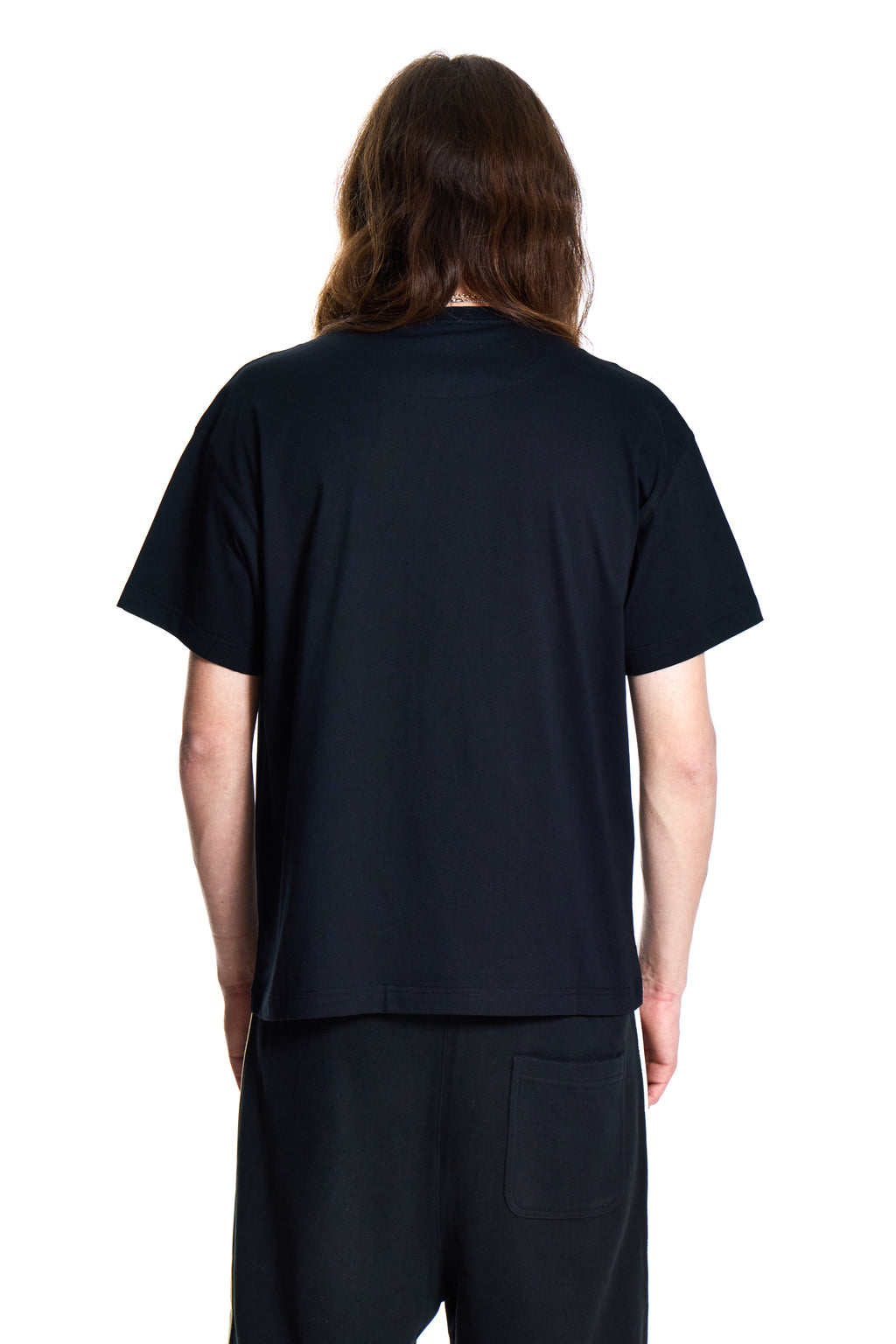 Person wearing a black t-shirt and pants on a white background