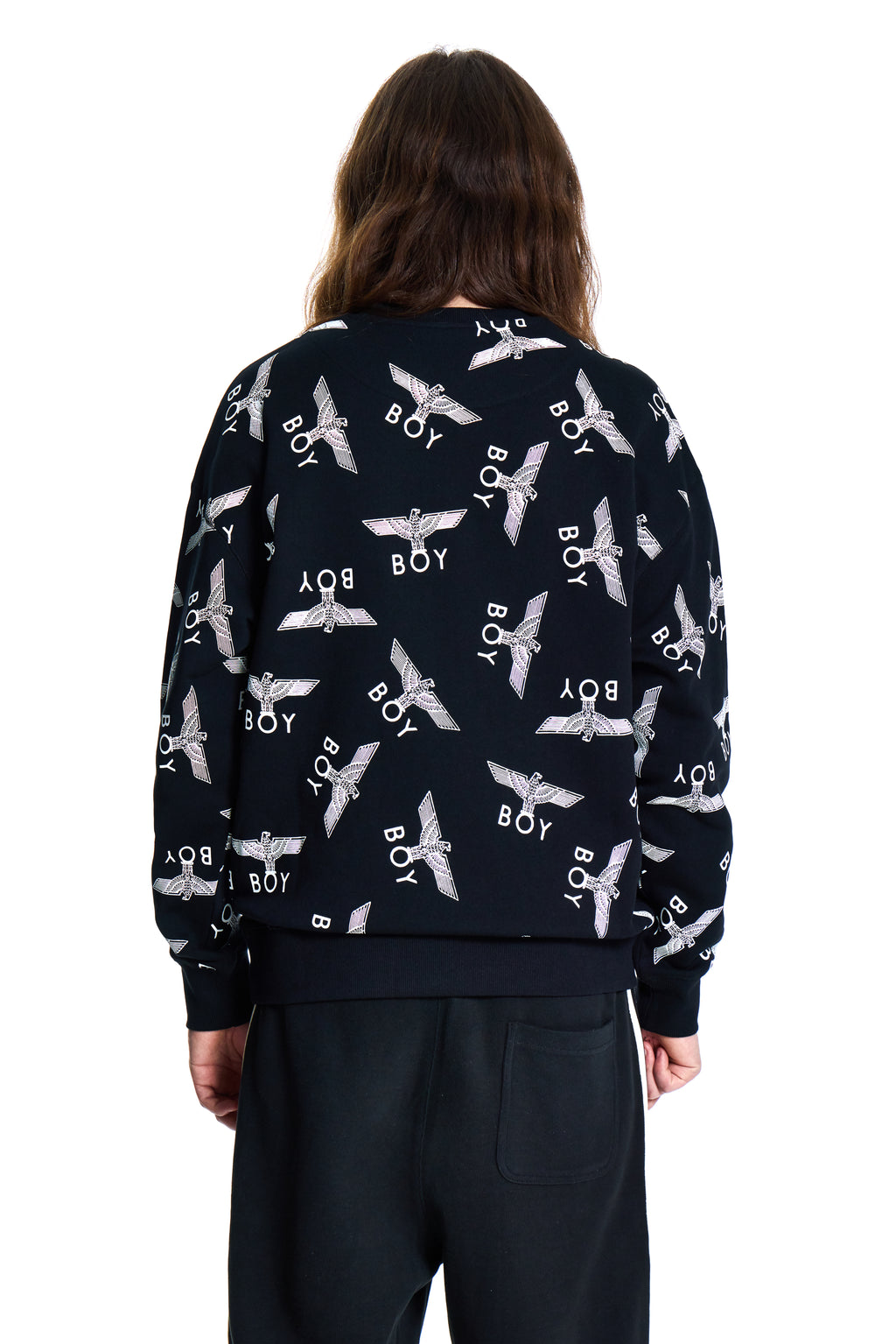 Person wearing a navy blue Boy London sweatshirt with white patterns and text, standing against a white background