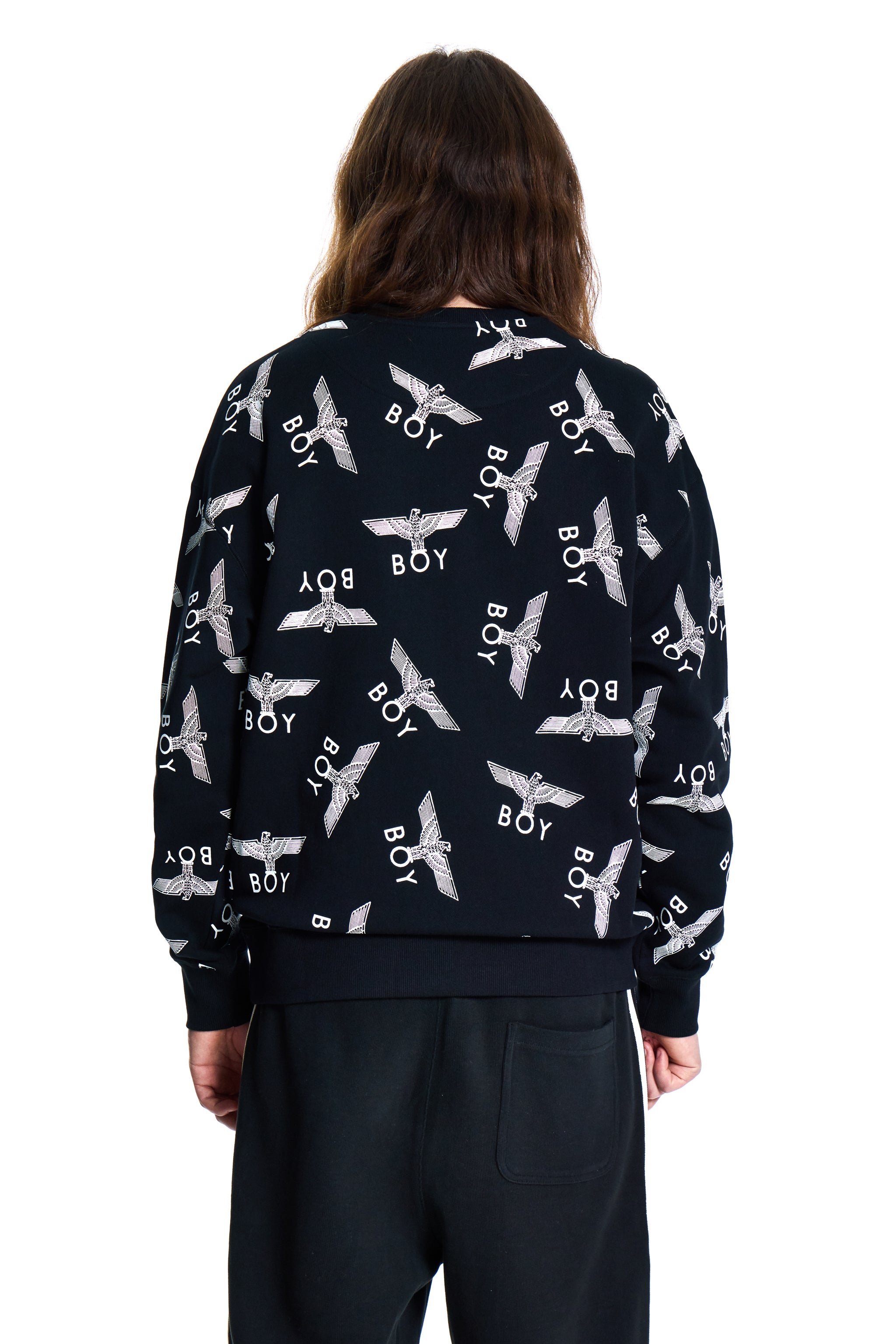 Person wearing a navy blue Boy London sweatshirt with white patterns and text, standing against a white background
