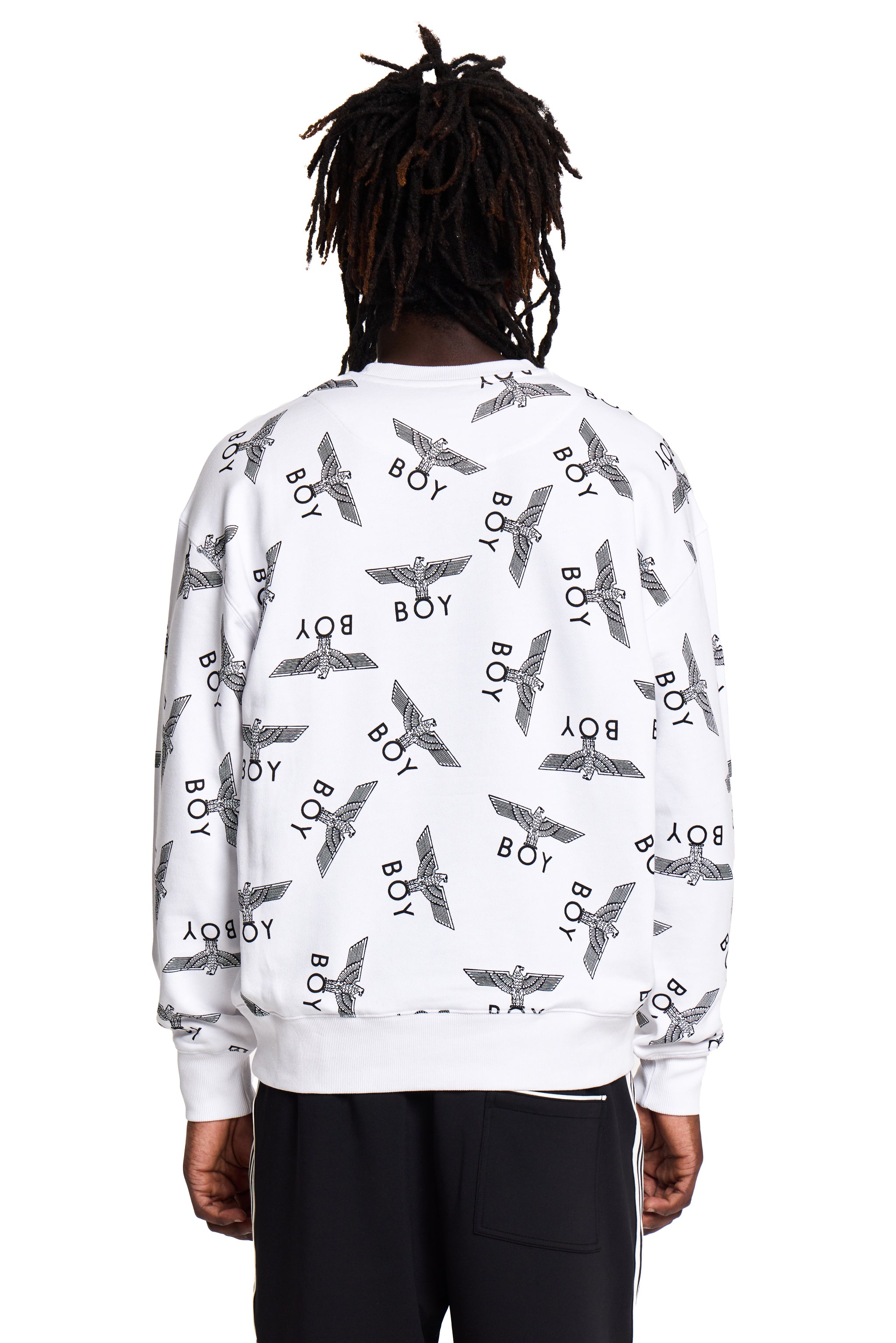 Person wearing a white Boy London sweatshirt with black patterns and text on a white background