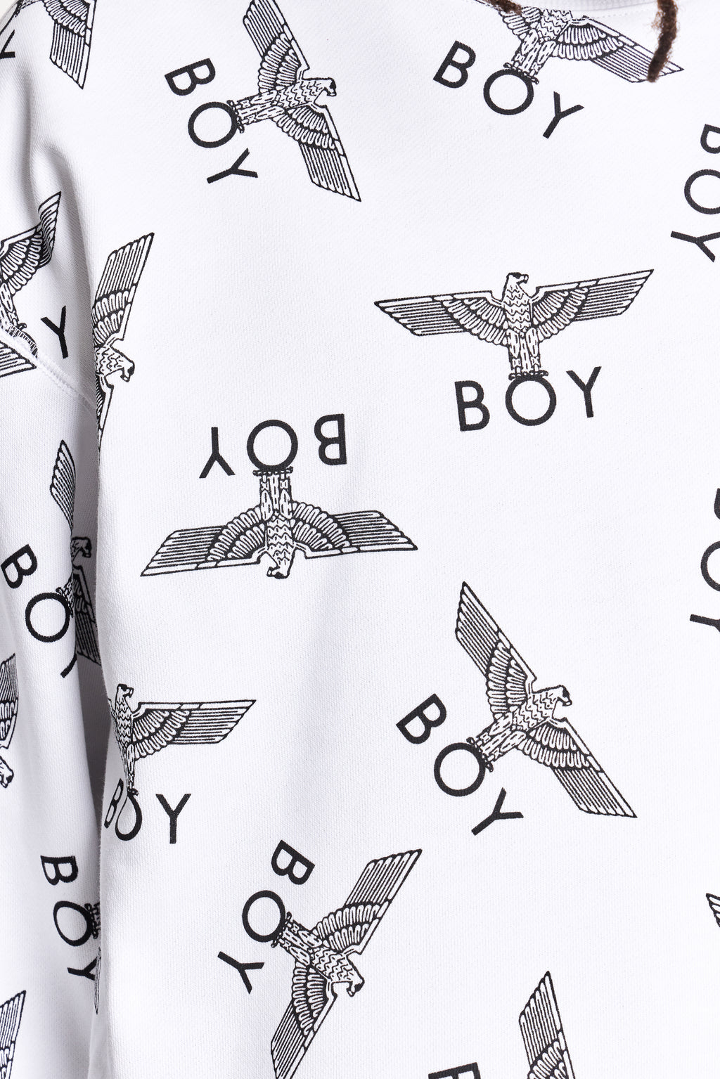 White fabric with black 'BOY' and eagle logo pattern by Boy London 