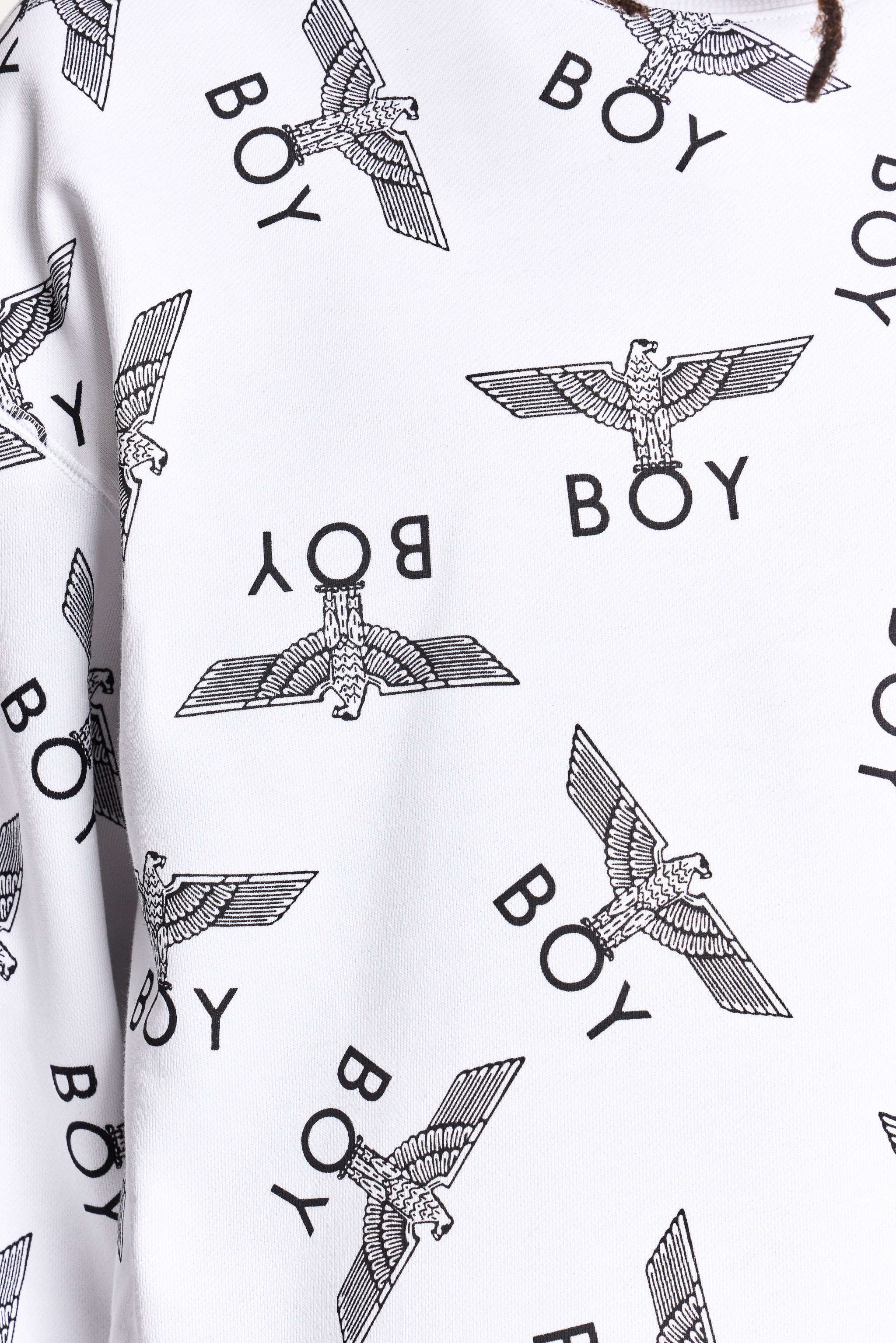 White fabric with black 'BOY' and eagle logo pattern by Boy London 
