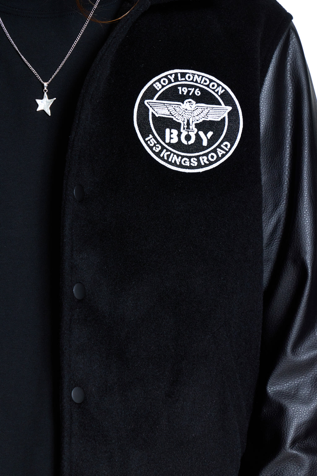 Black jacket with 'BOY' logo on a black background