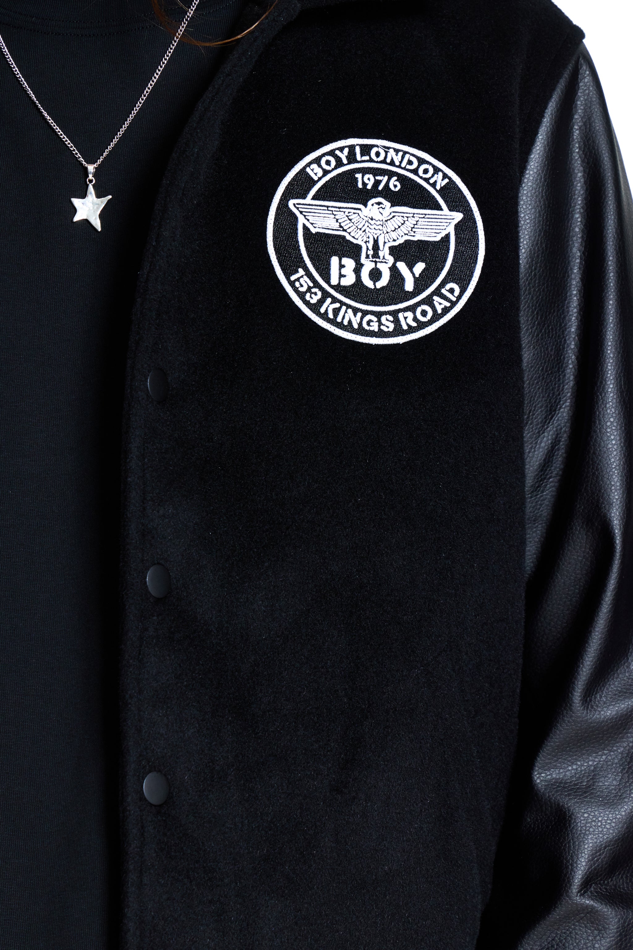 Black jacket with 'BOY' logo on a black background