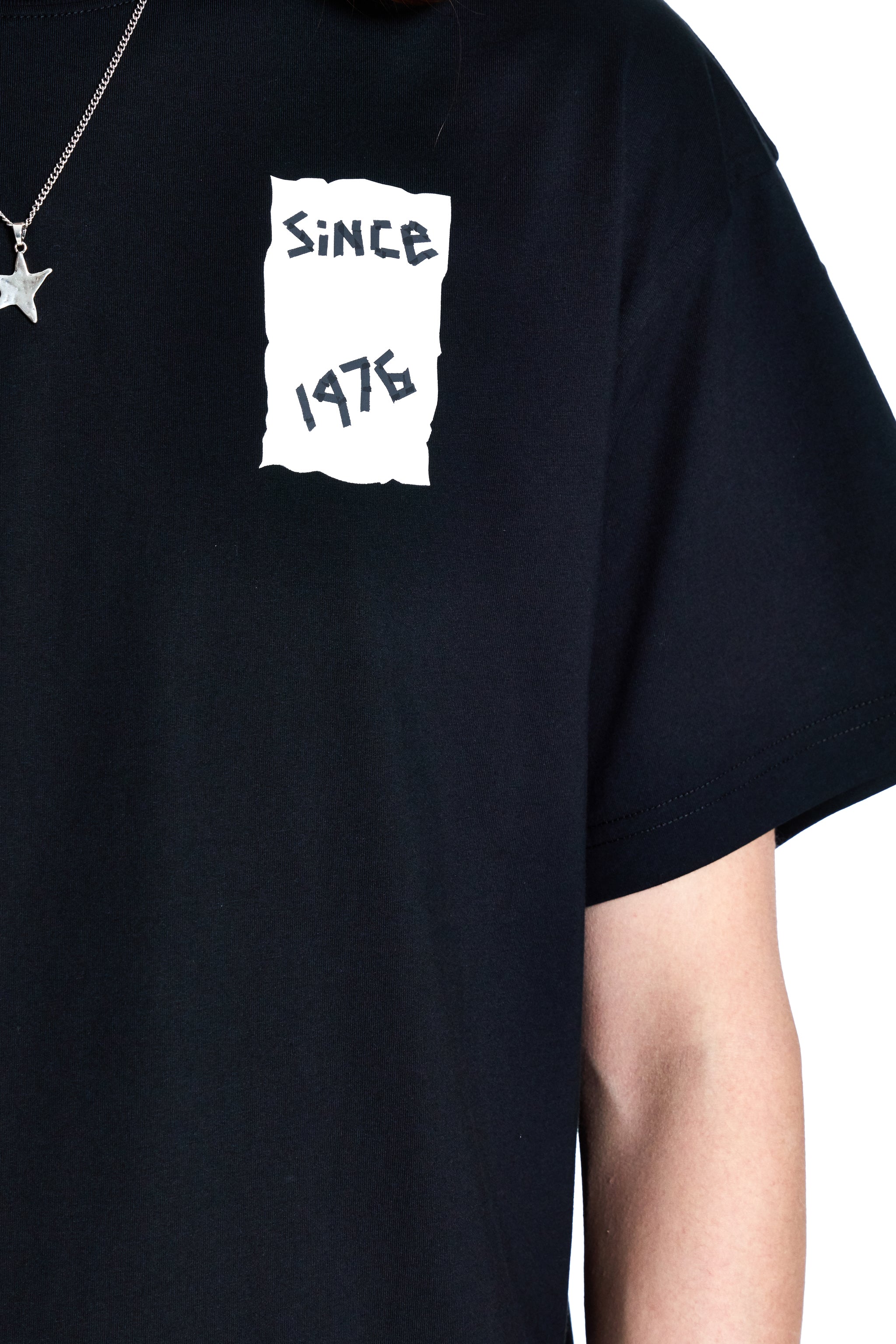 Black t-shirt with 'Since 1976' text design on a plain background