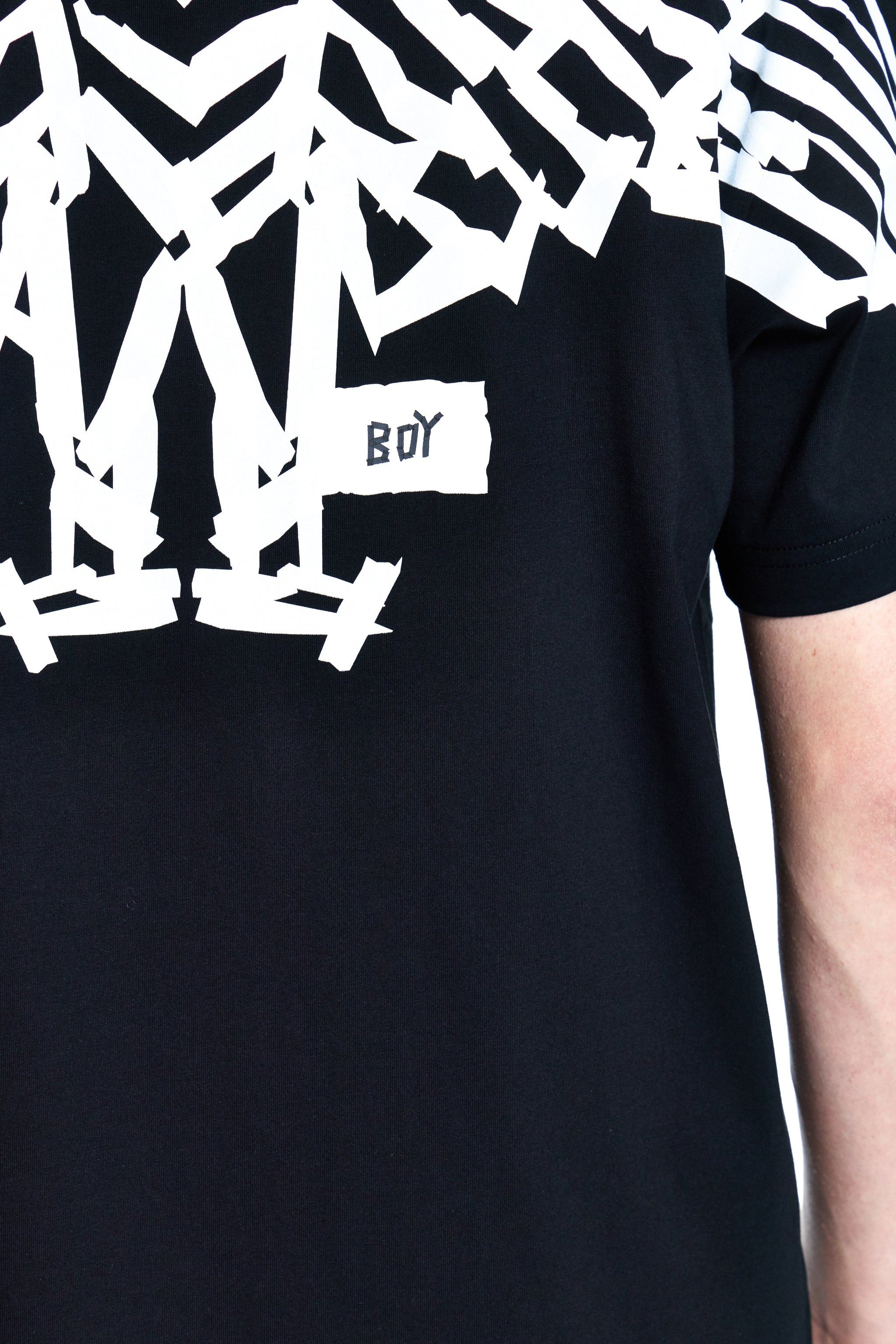 Black t-shirt with white graphic design on a person wearing it.