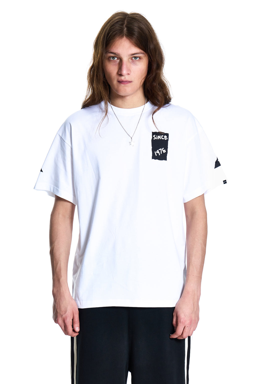 Person wearing a white t-shirt with black text on a white background