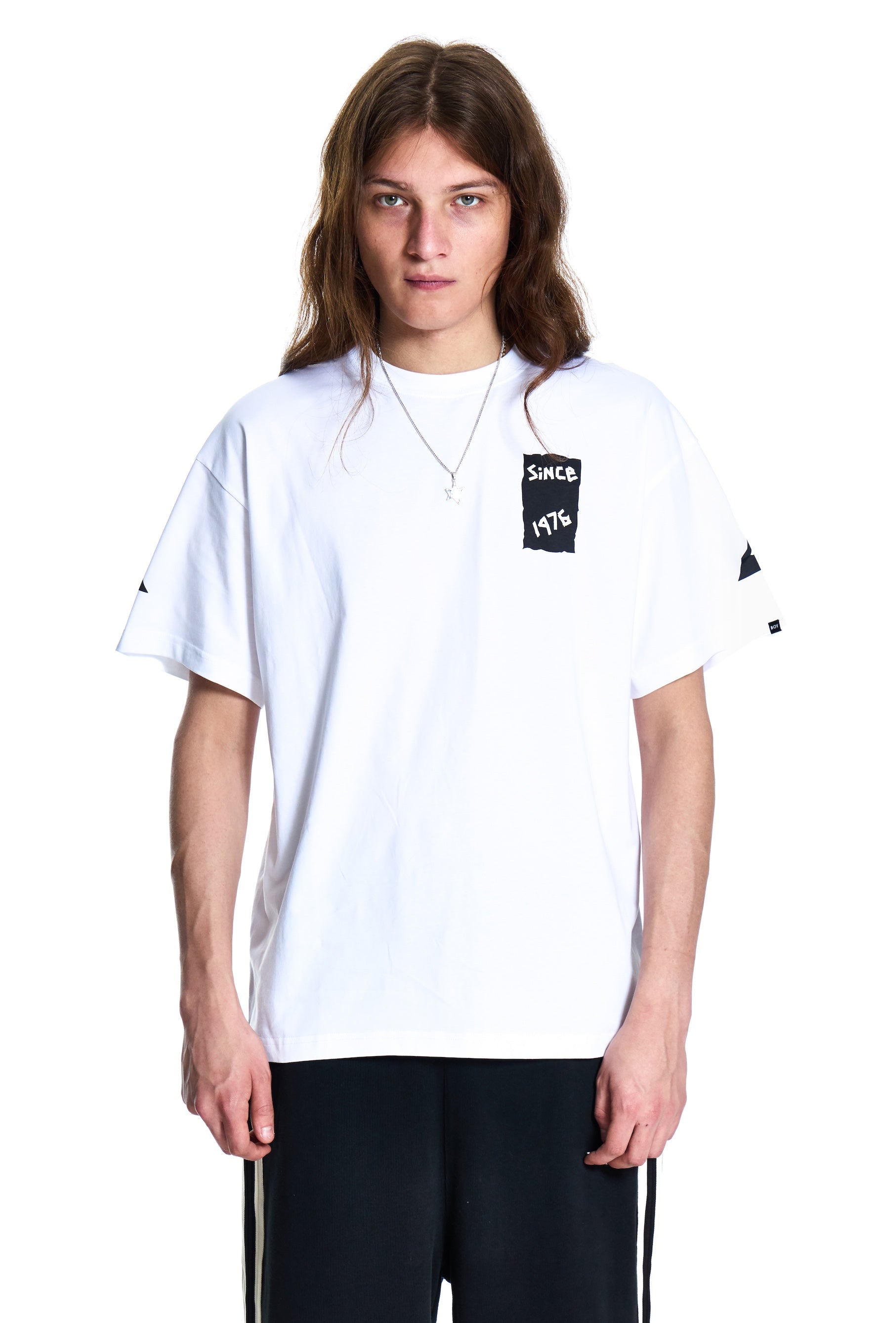 Person wearing a white t-shirt with black text on a white background