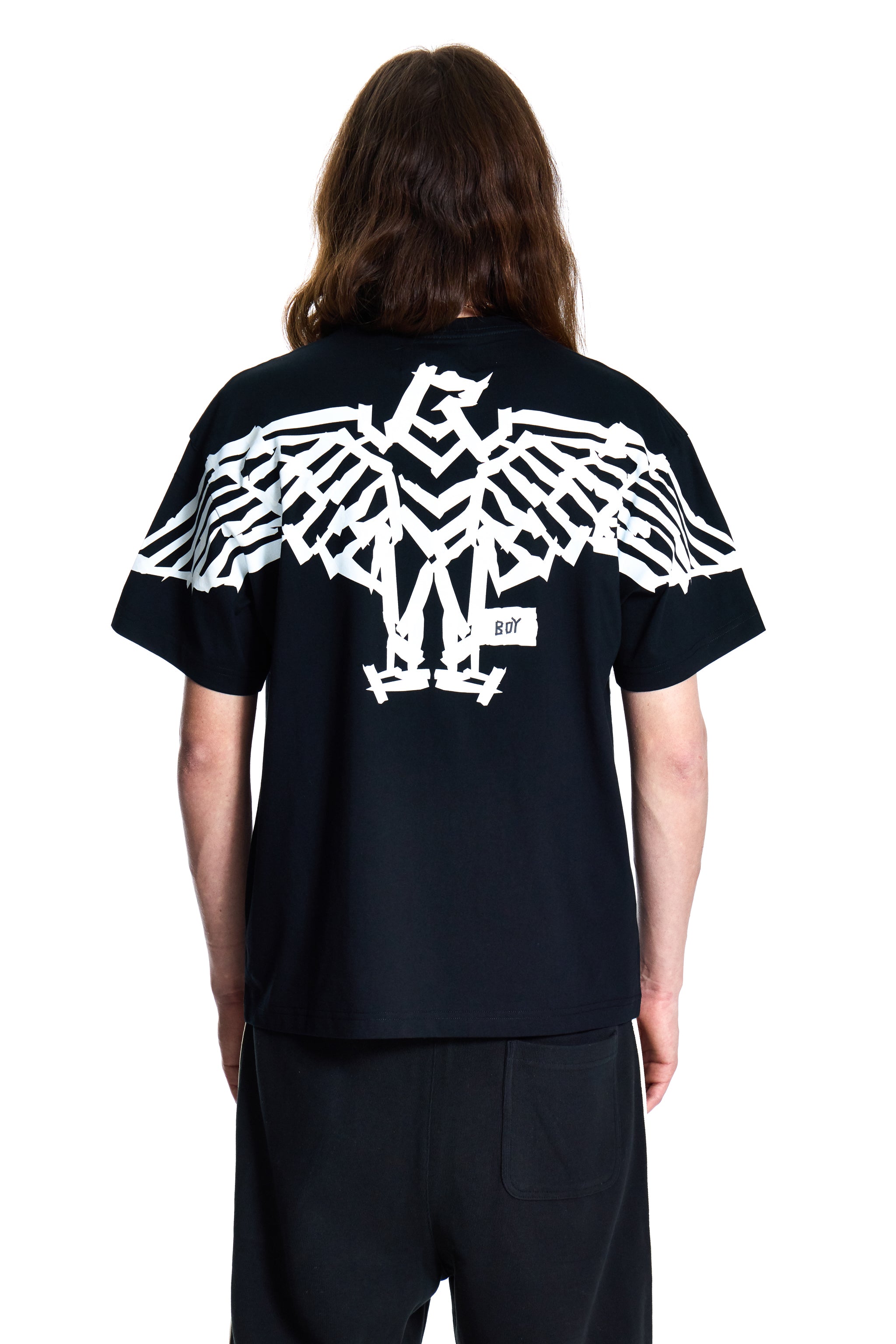 Person wearing a black t-shirt with a white eagle design on the back, standing against a white background.