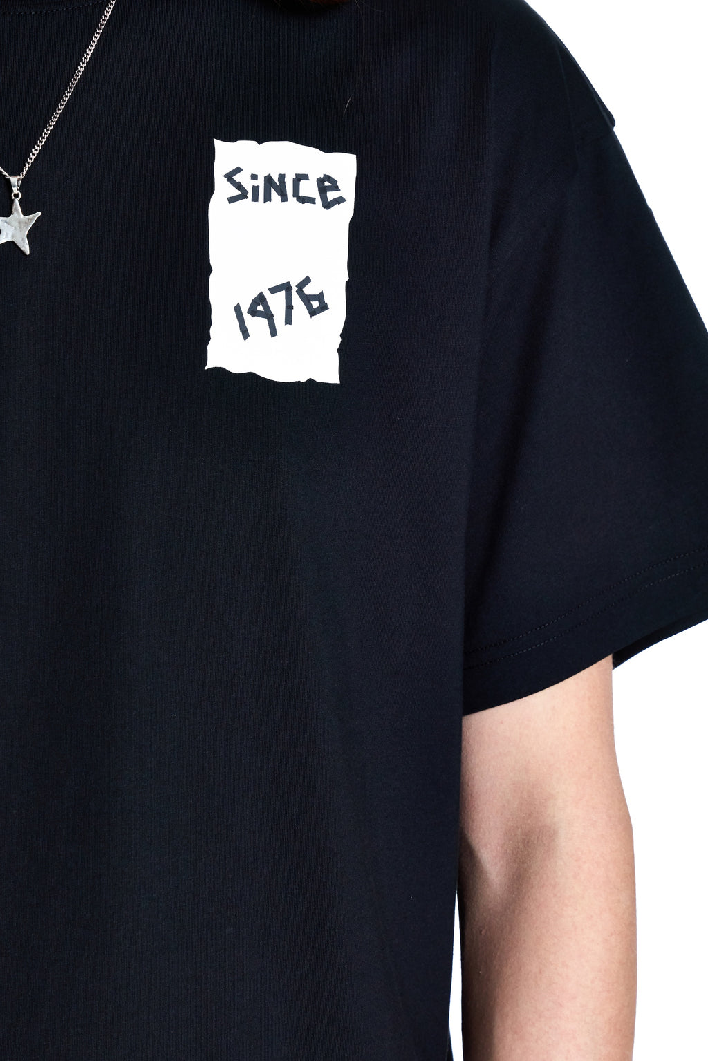 Black t-shirt with 'Since 1976' text on a white background