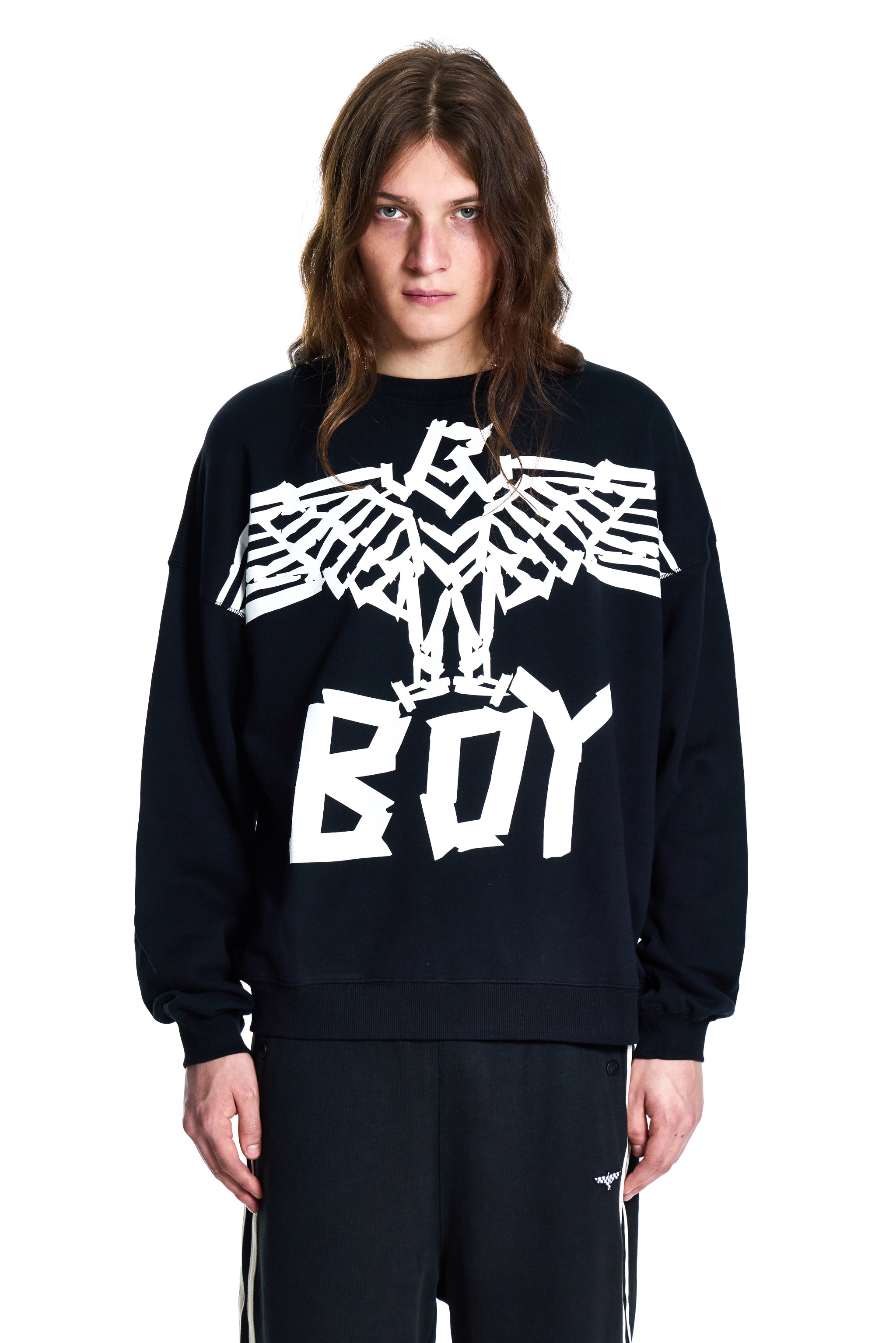 Person wearing a black Boy London sweatshirt with a white eagle design and 'BOY' text on a white background