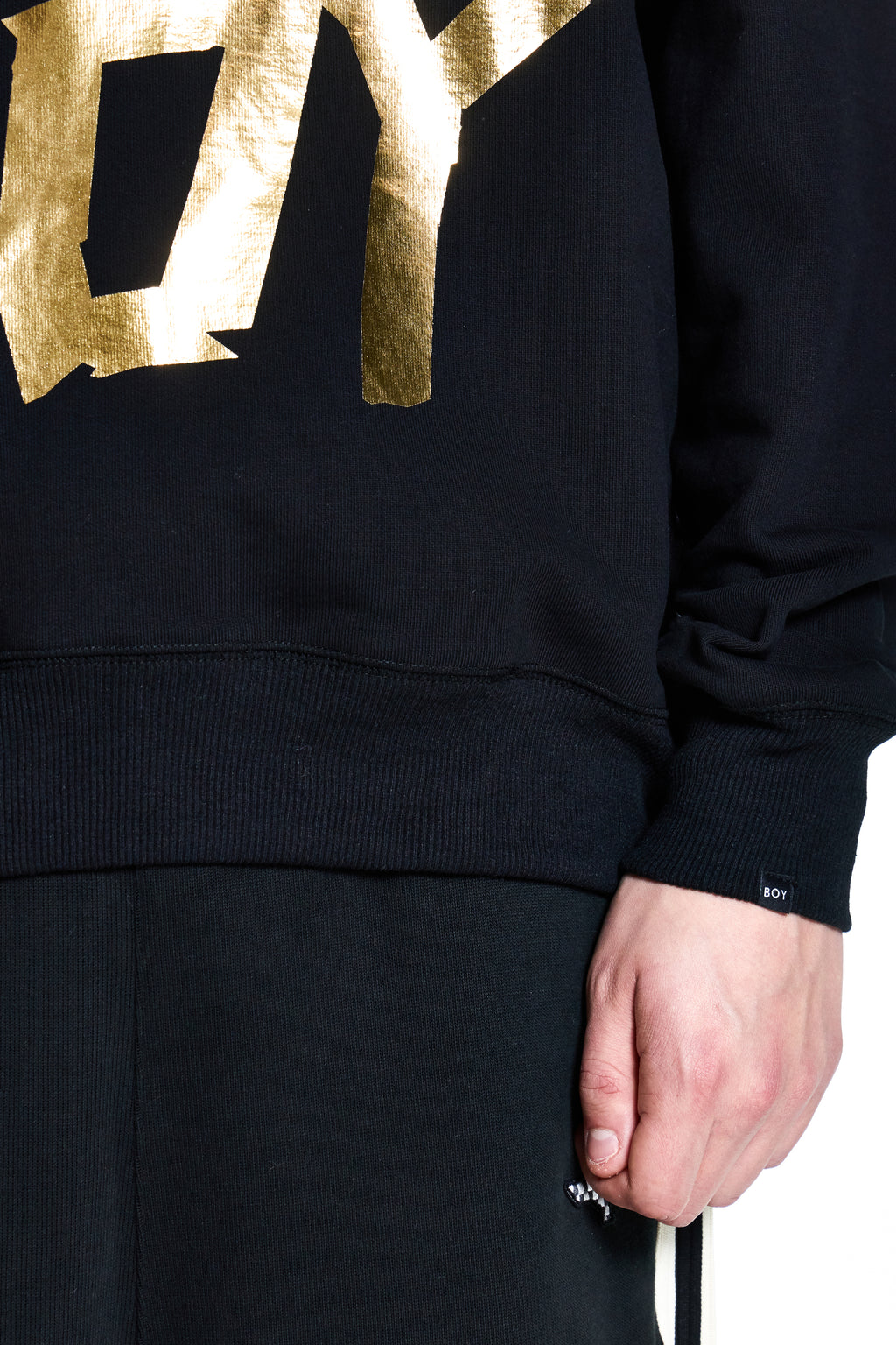 Black hoodie with gold lettering on a white background