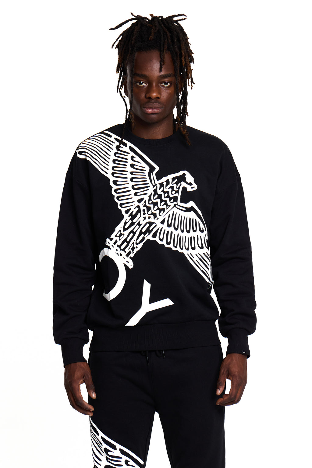Model wearing a black BOY London sweatshirt with a white eagle design on a white background