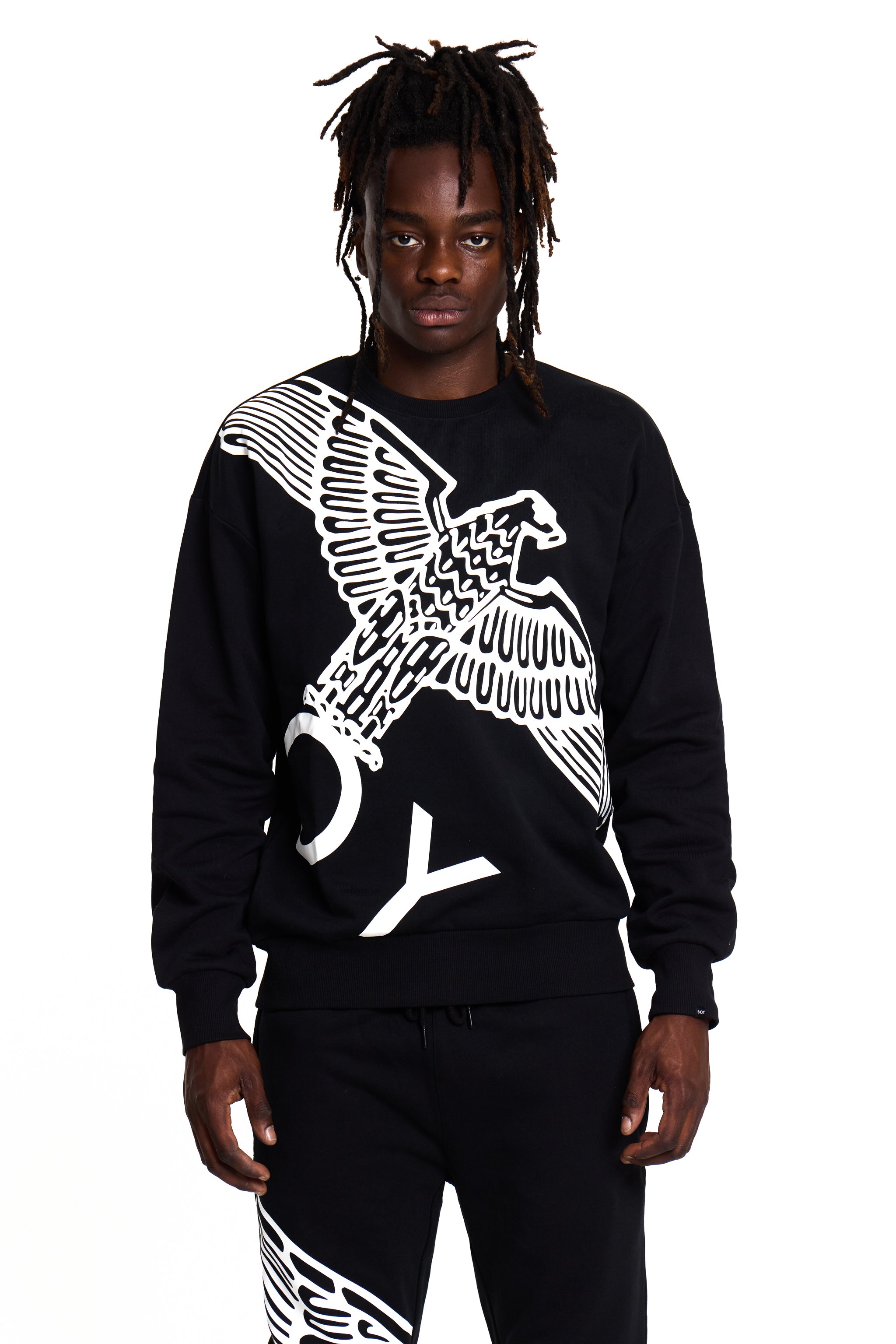 Model wearing a black BOY London sweatshirt with a white eagle design on a white background