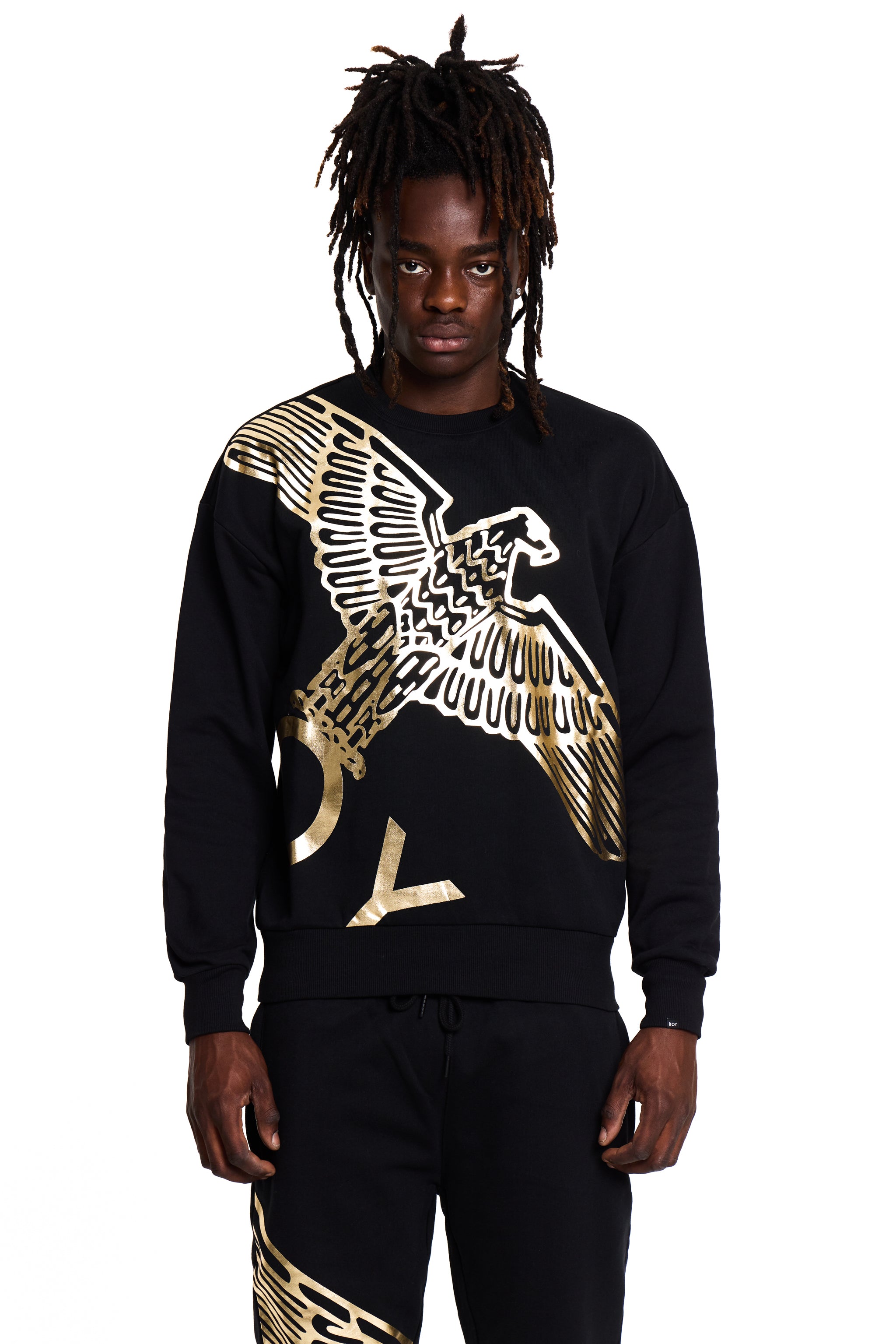 Model wearing a black BOY London sweatshirt with a gold eagle design on a white background