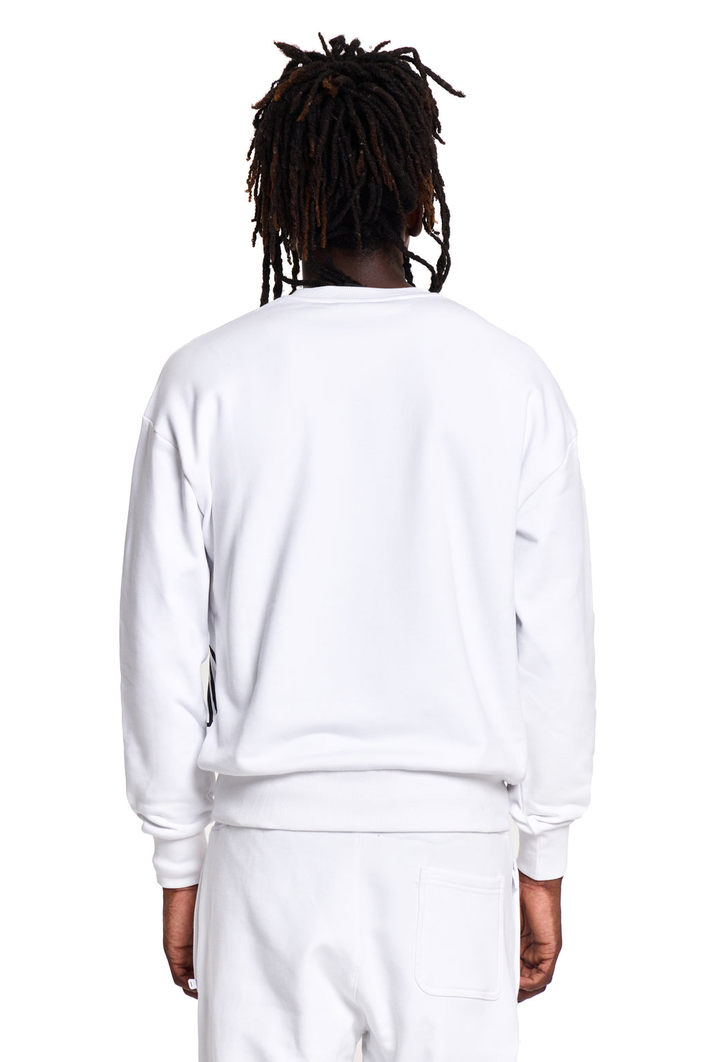 Model wearing a white BOY London sweatshirt and pants on a white background