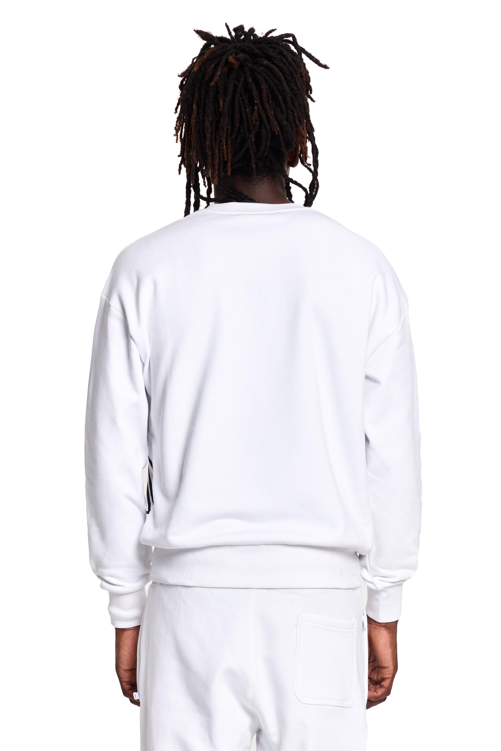 Model wearing a white BOY London sweatshirt and pants on a white background