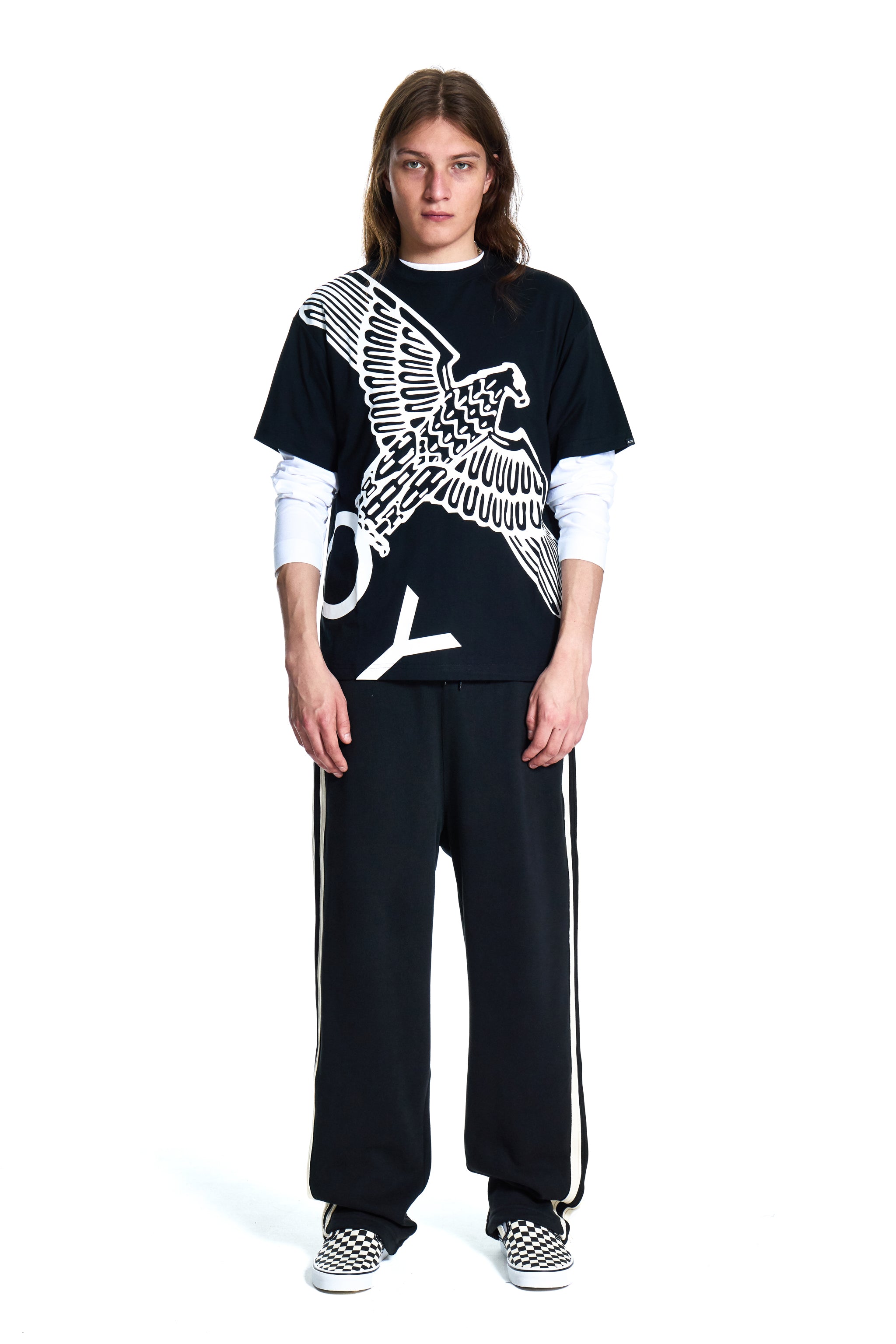 Person wearing a black Boy London outfit with a white eagle design on a white background