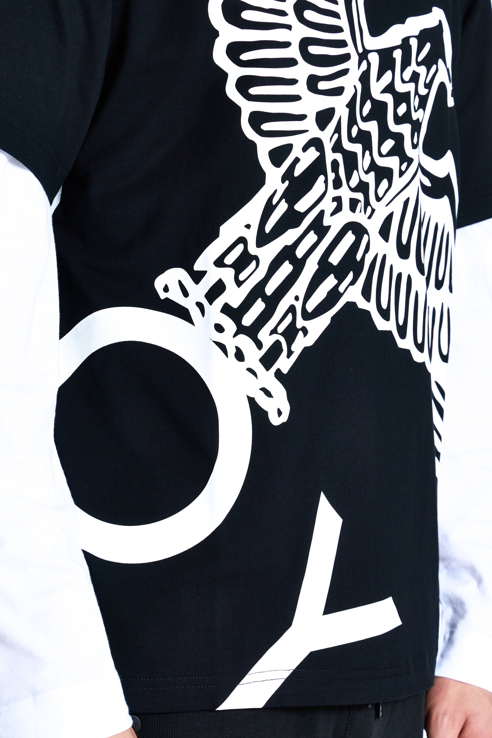 Black t-shirt with white graphic design on a plain background