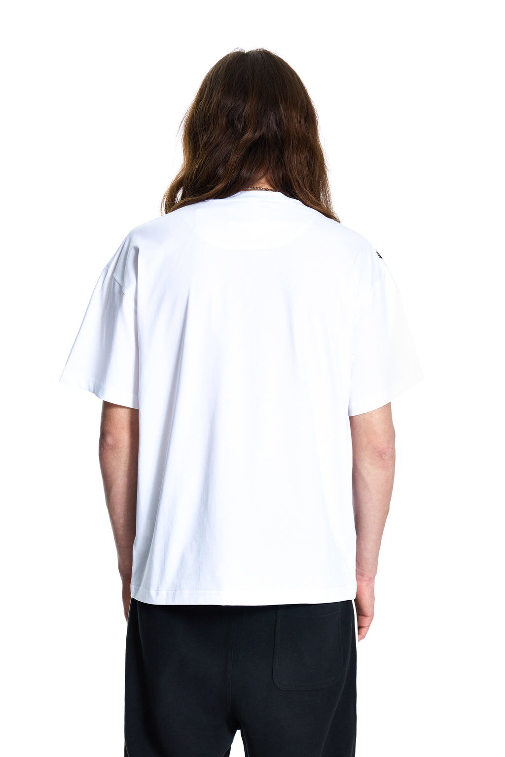 Person wearing a plain white t-shirt on a white background