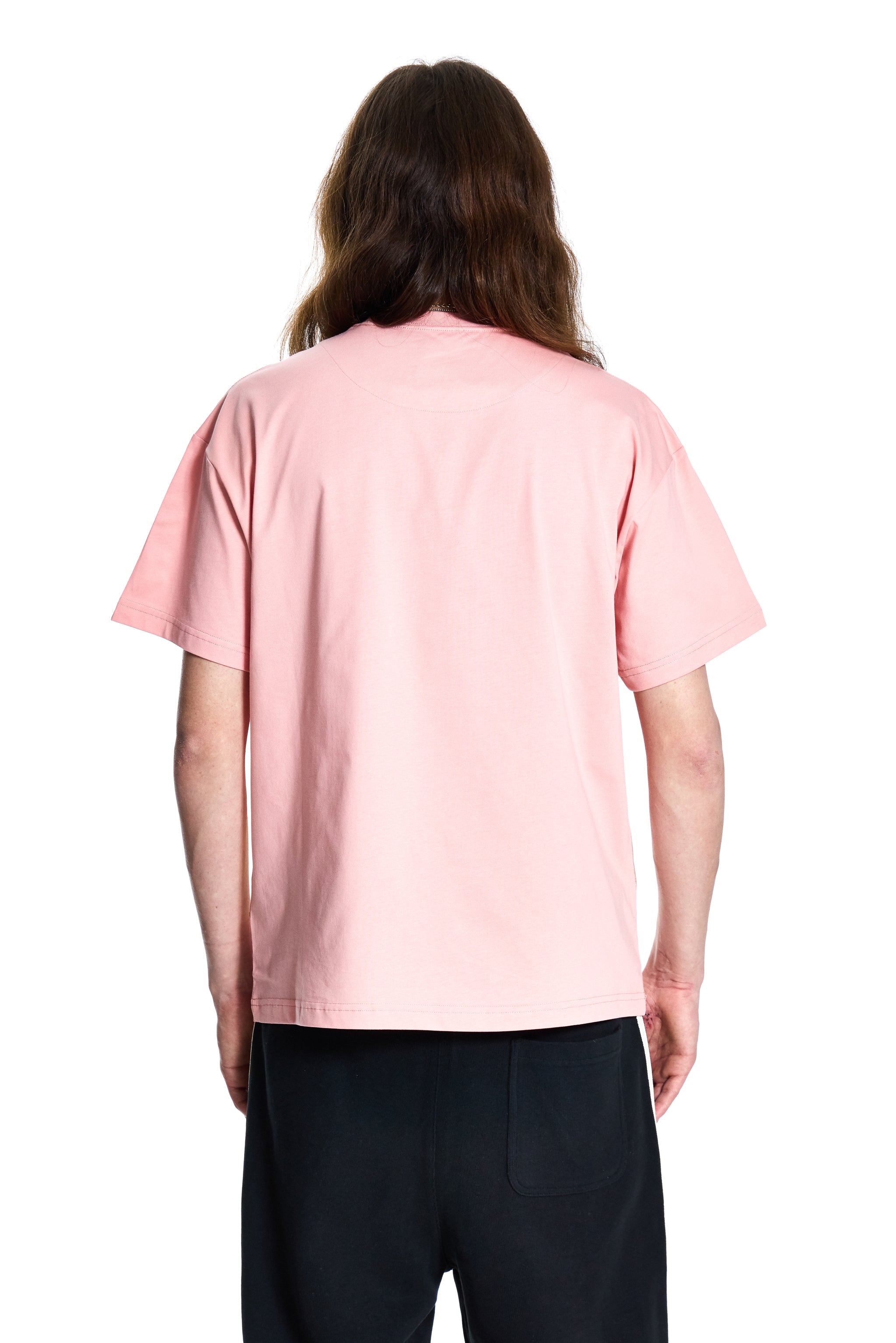 Person wearing a pink t-shirt on a white background