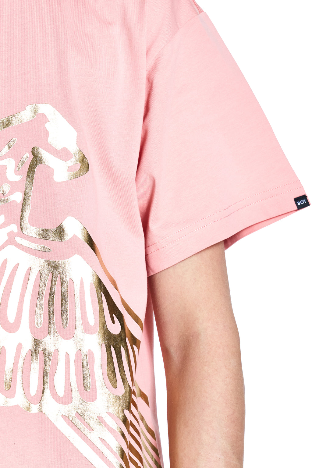 Pink t-shirt with gold and white graphic design on a white background