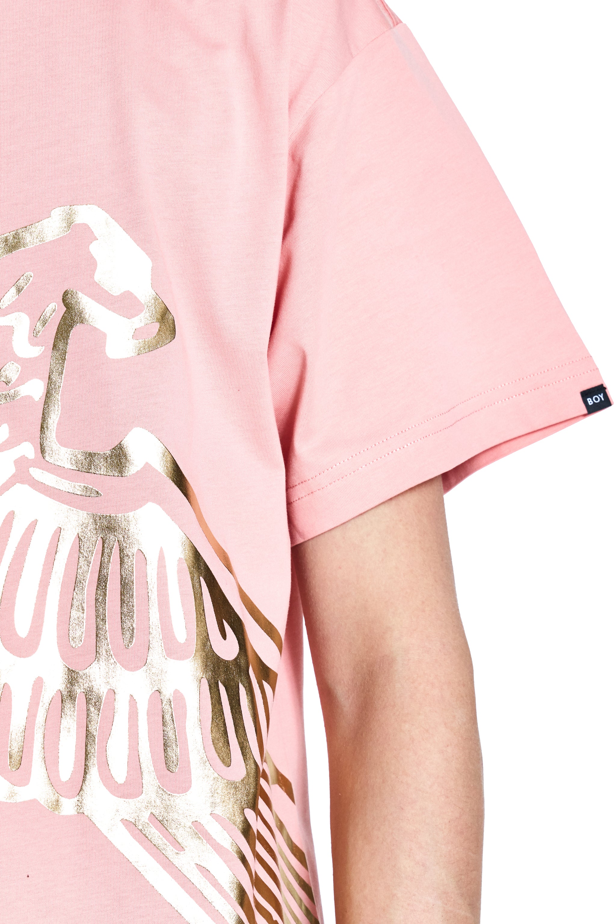 Pink t-shirt with gold and white graphic design on a white background