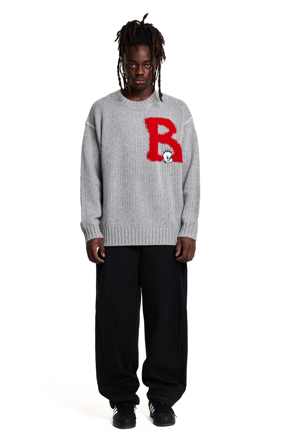 Person wearing a gray Boy London sweater with a red 'B' logo on a white background