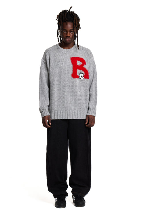 Person wearing a gray Boy London sweater with a red 'B' logo on a white background