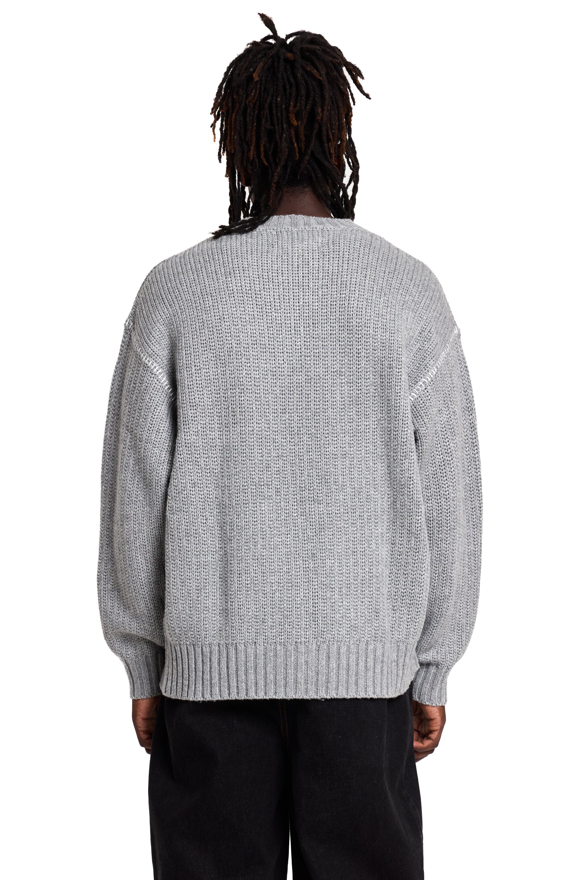 Person wearing a gray Boy London sweater from behind on a white background