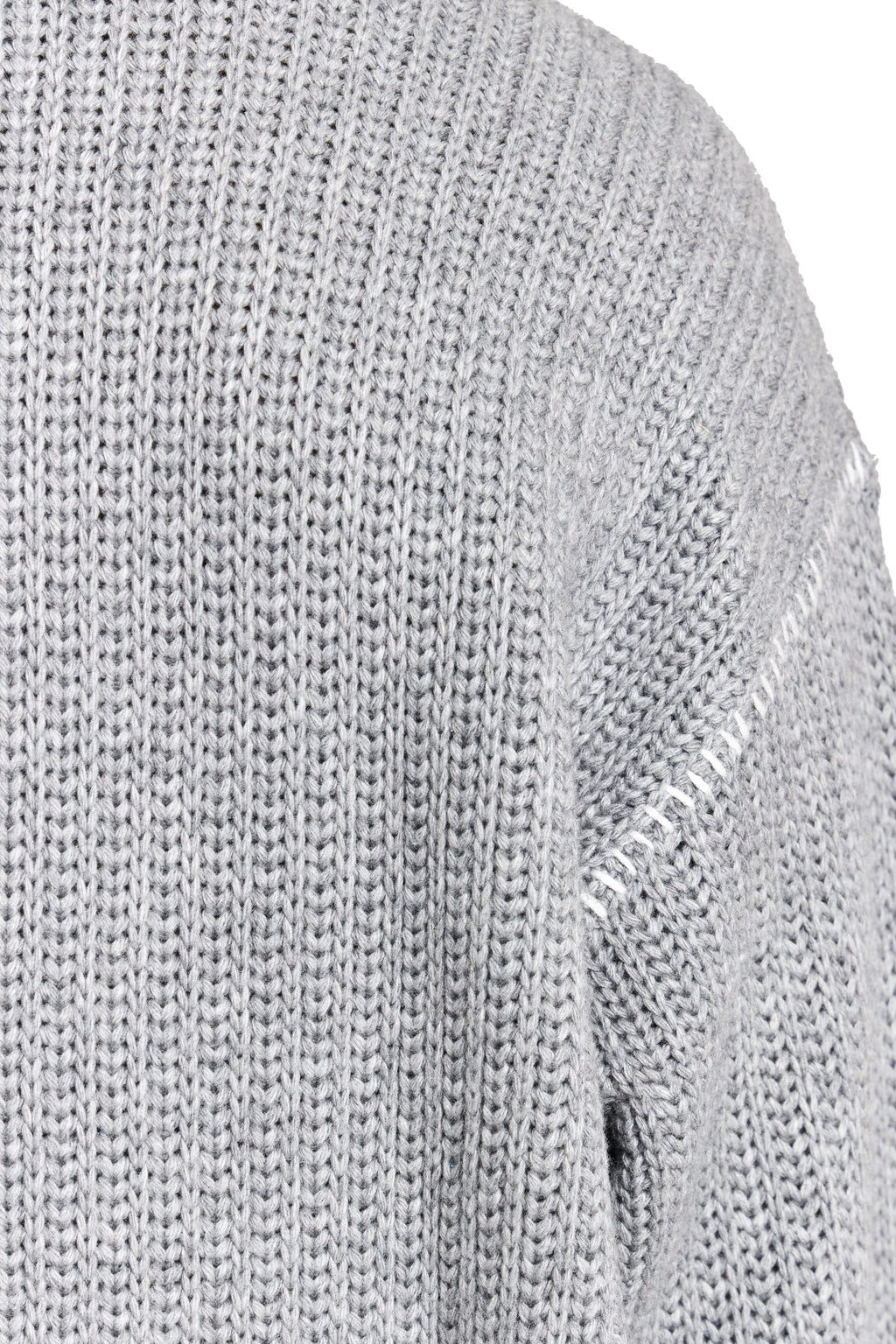 Close-up of a gray knit sweater with brand logo.