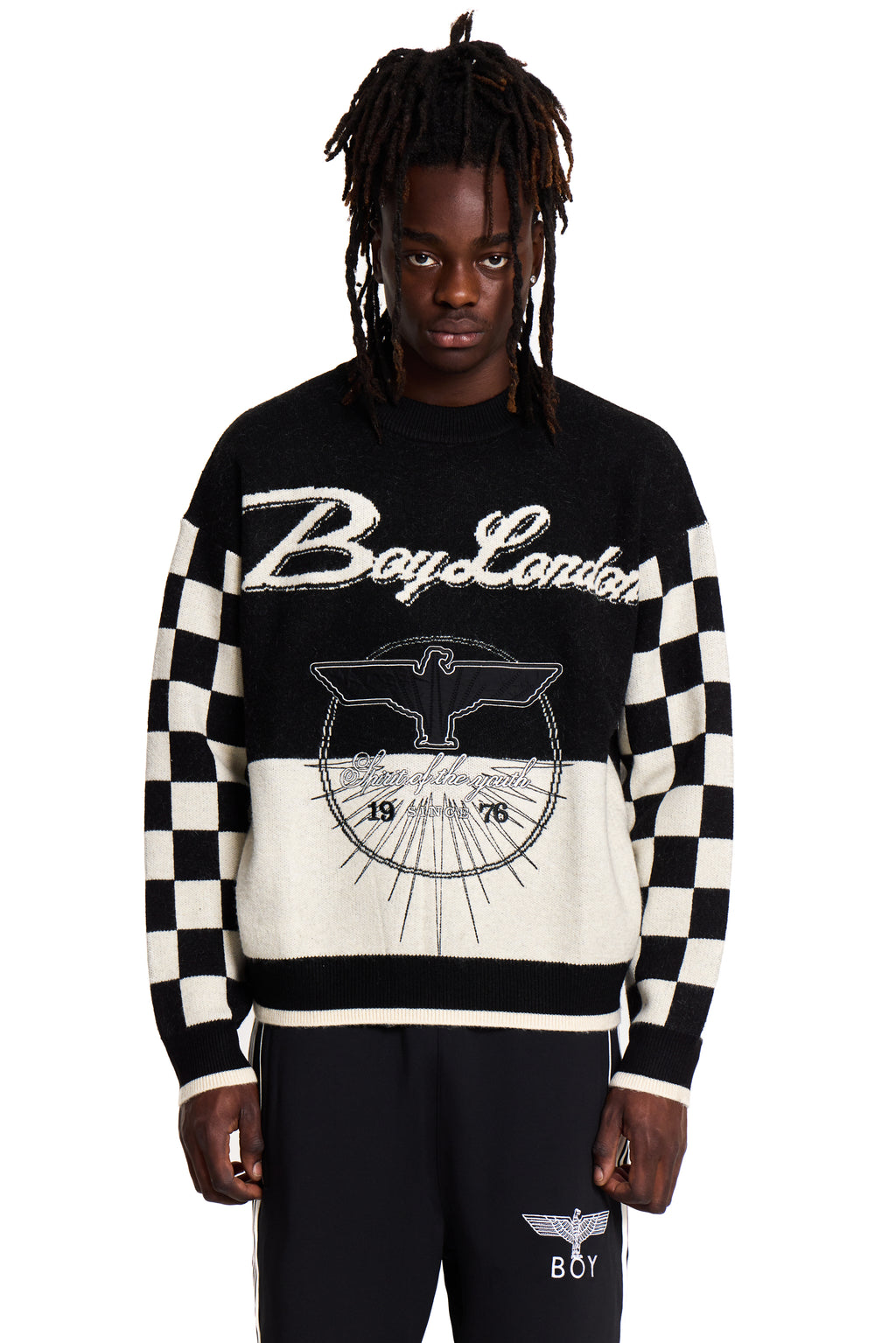 Person wearing a black and white Boy London checkered sweater with 'Boy London' branding on a white background