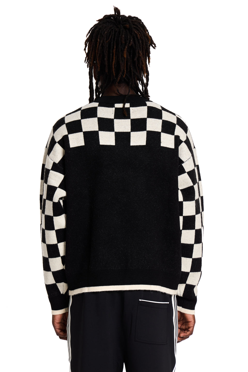 Person wearing a black and white checkered jacket on a white background