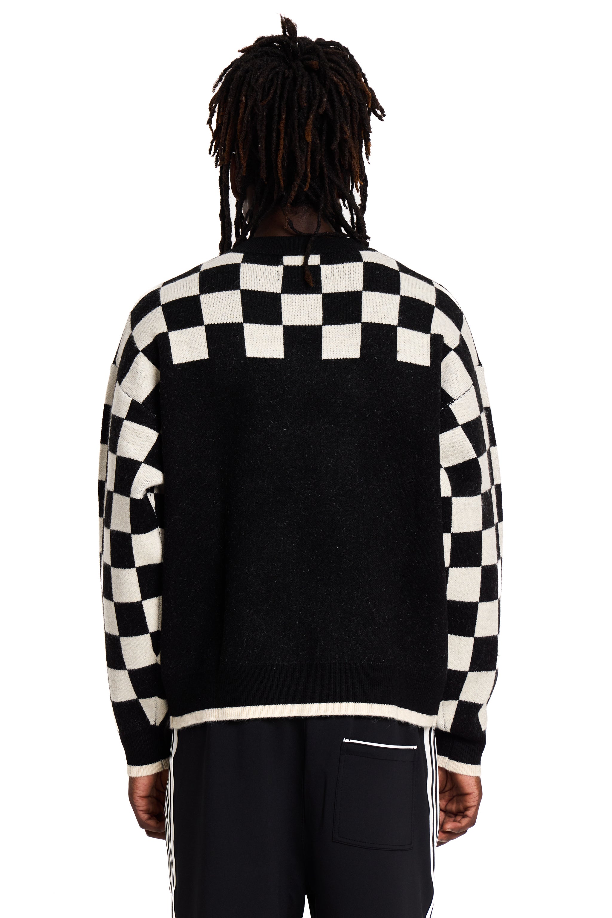 Person wearing a black and white checkered jacket on a white background