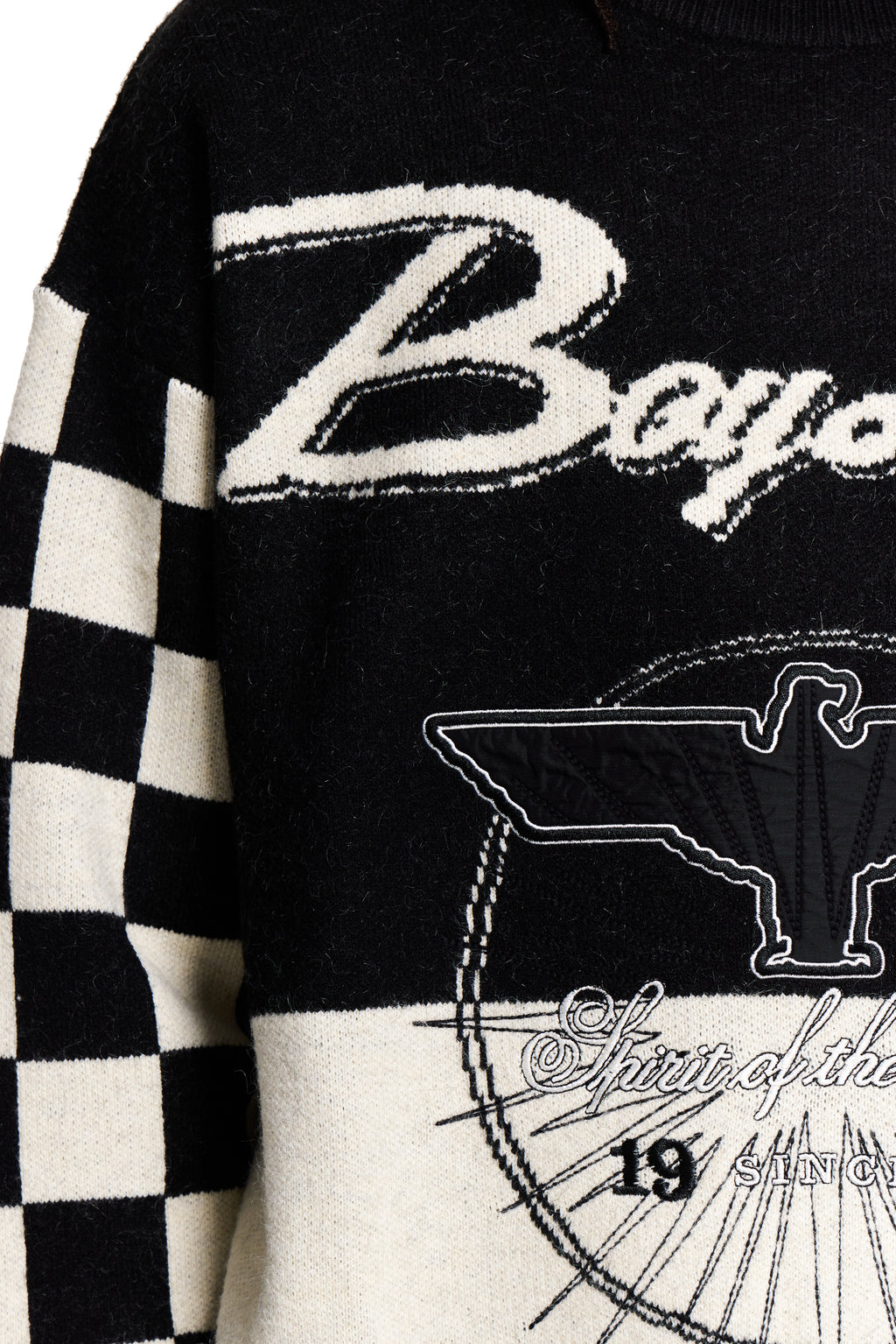 Black and white sweater with 'Boy' text and eagle design on a checkered sleeve.