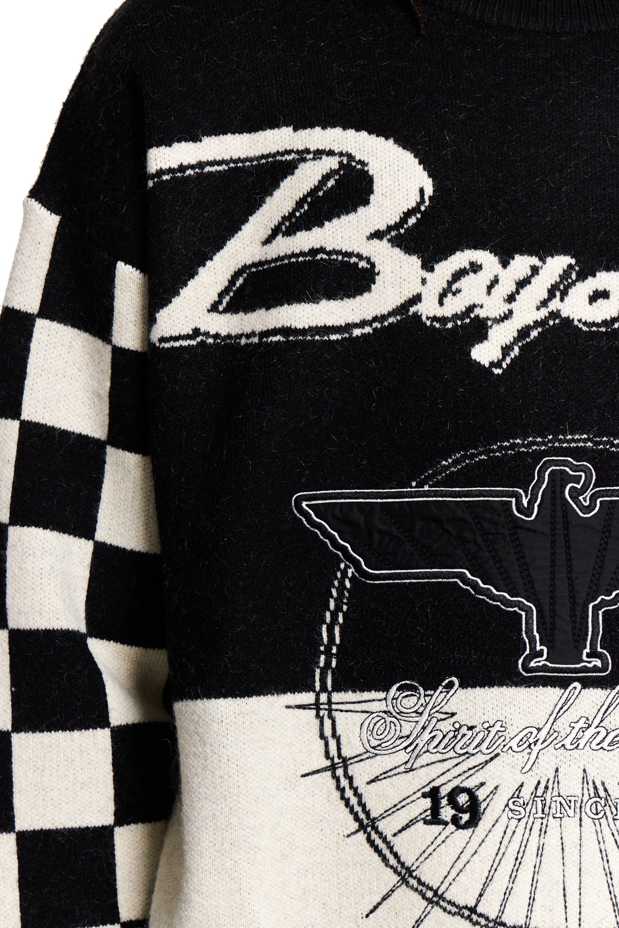 Black and white sweater with 'Boy' text and eagle design on a checkered sleeve.