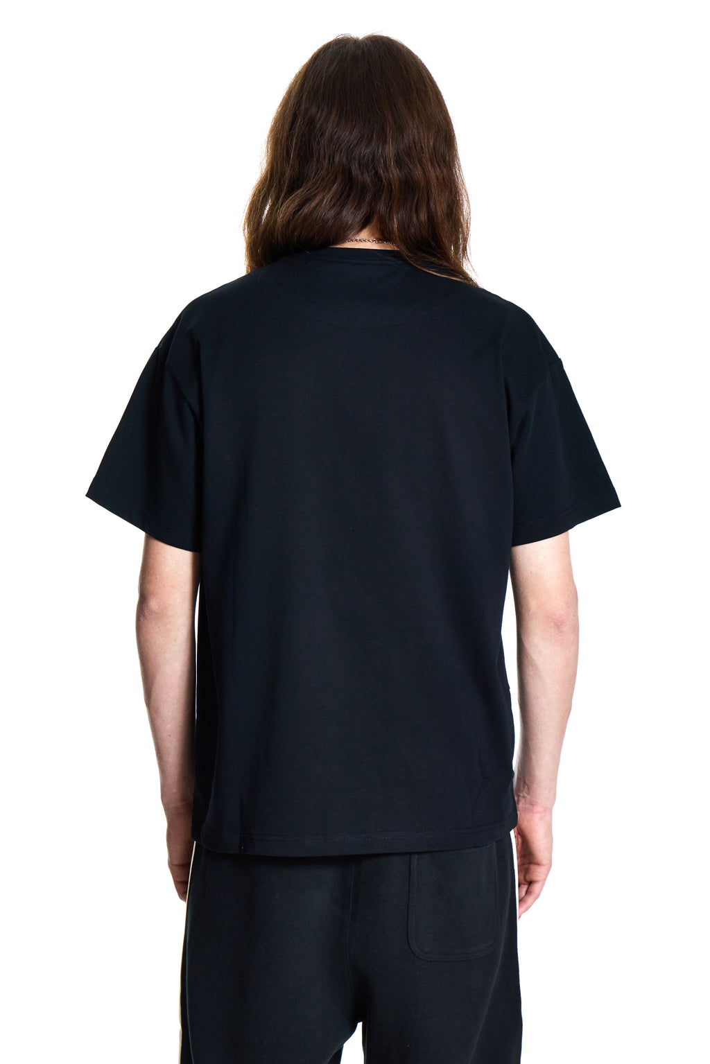 Person wearing a black t-shirt and pants on a white background