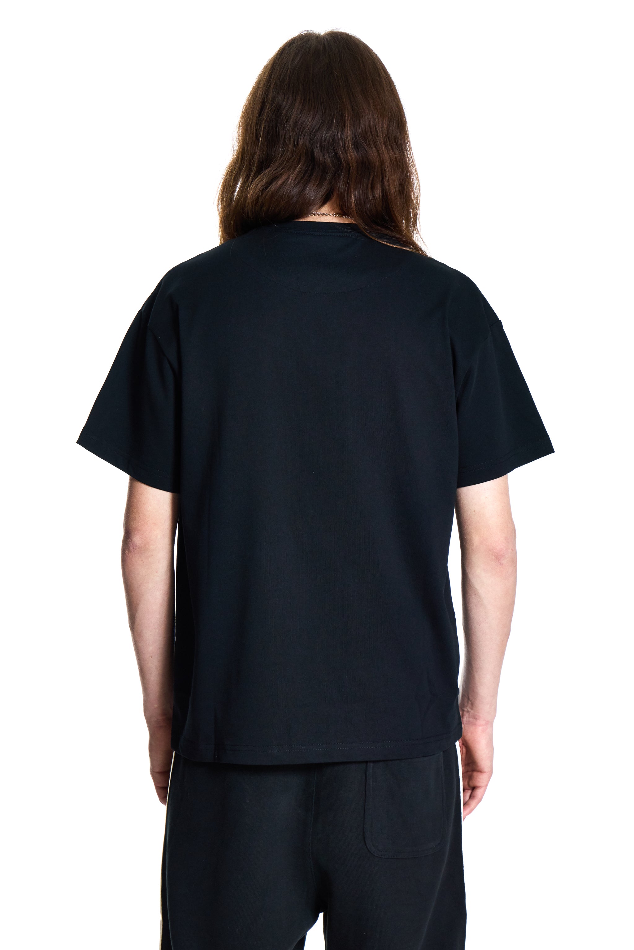 Person wearing a black t-shirt and pants on a white background