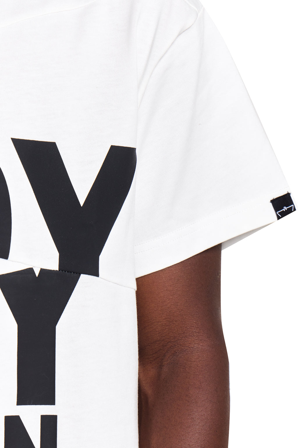White t-shirt with black text worn by a person on a white background