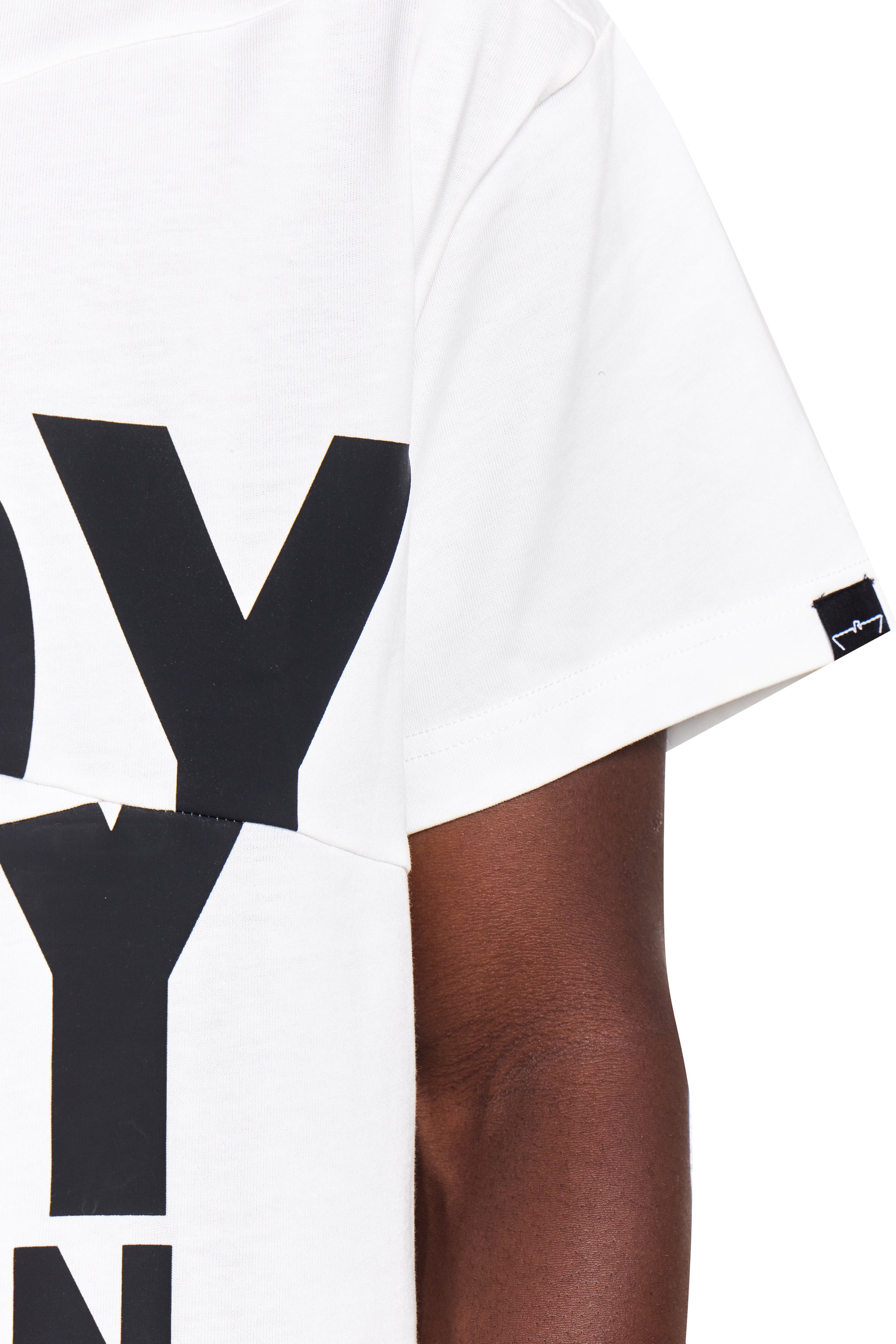 White t-shirt with black text worn by a person on a white background