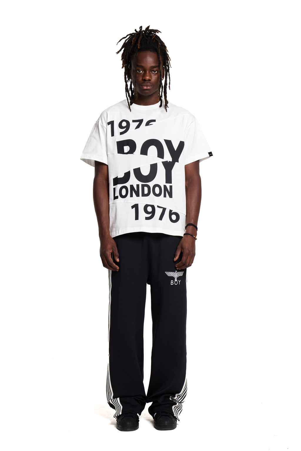 Person wearing a white 'BOY LONDON' t-shirt with black text on a white background