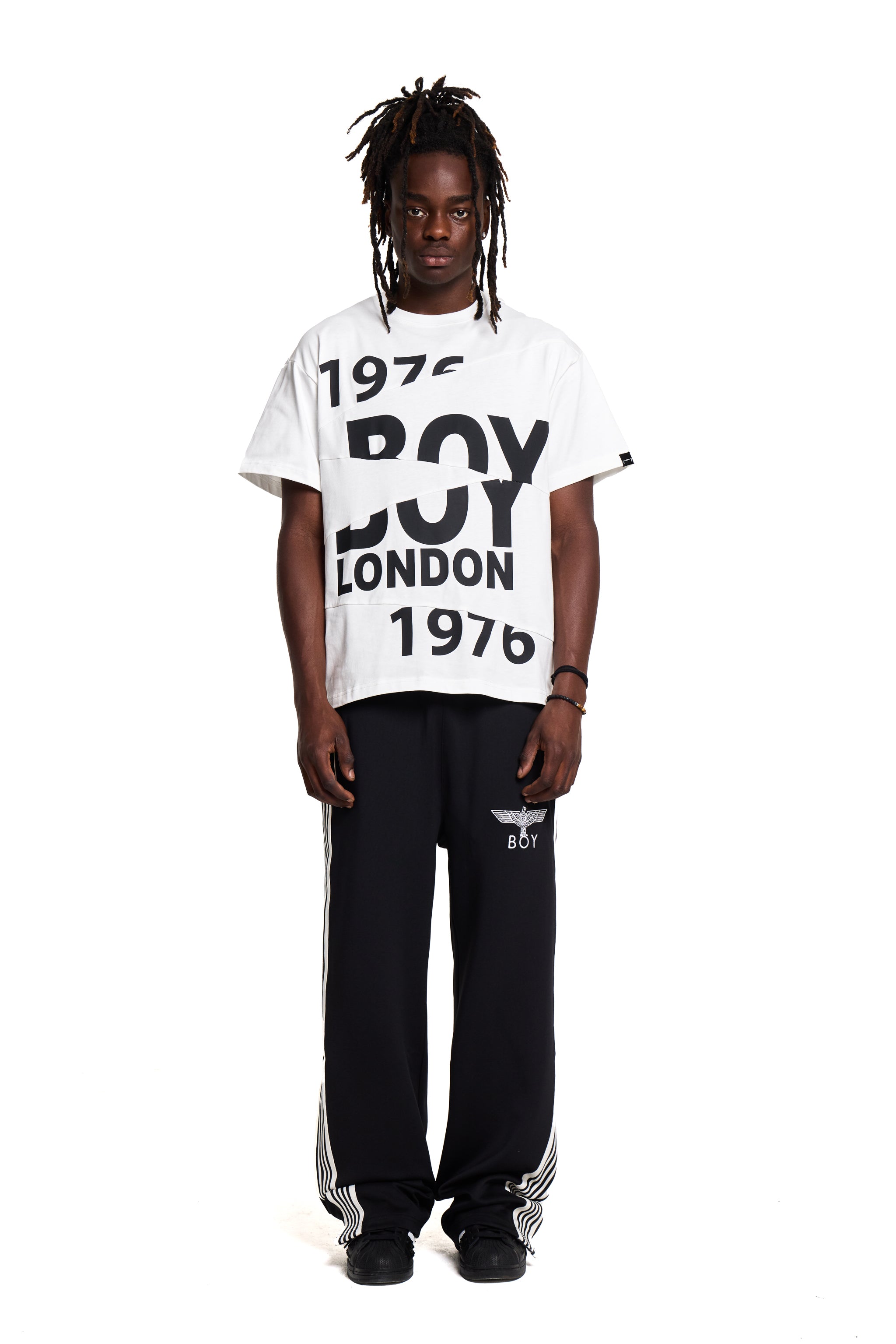Person wearing a white 'BOY LONDON' t-shirt with black text on a white background
