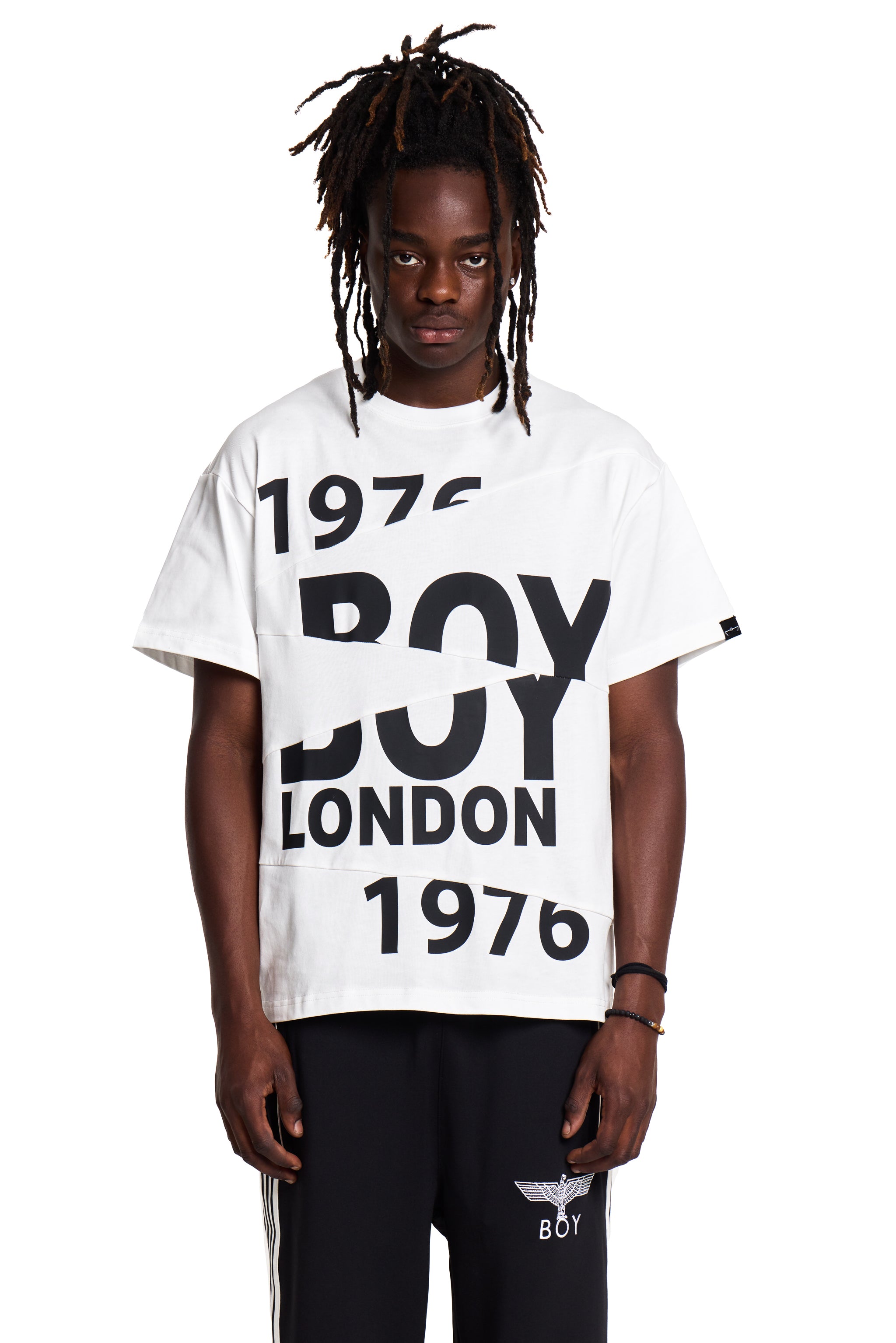 Person wearing a white t-shirt with 'BOY LONDON 1976' text on a white background
