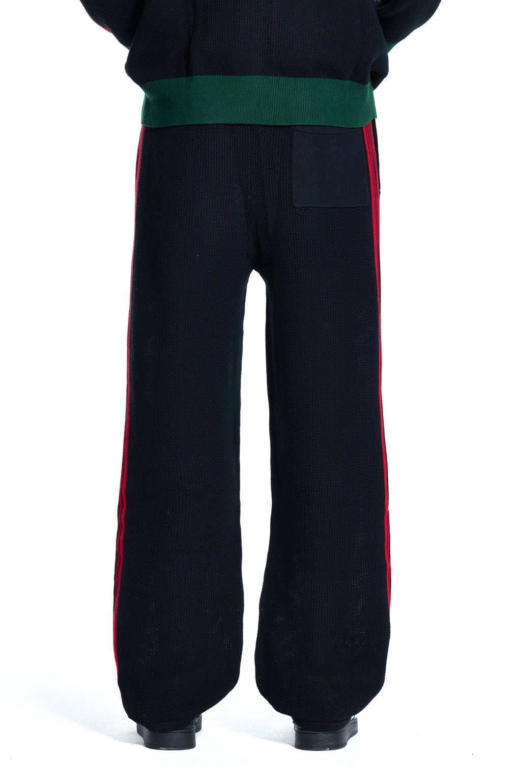 Black BOY London pants with green waistband and red side stripes on a white background