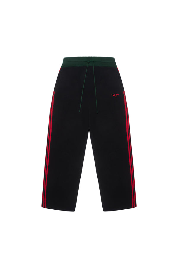 BOY London pants with red side stripe on a white background