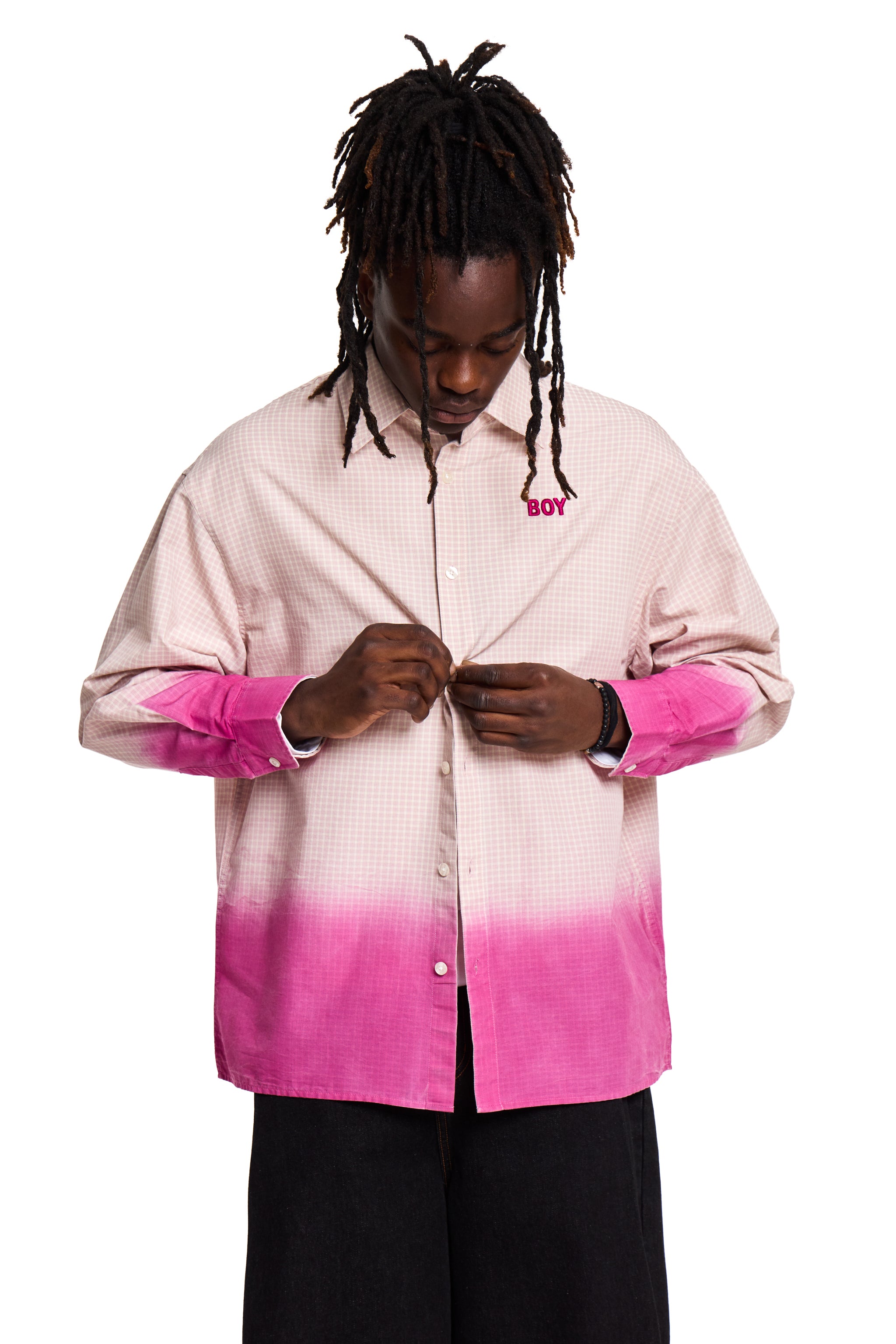 Person wearing a pink and white Boy London gradient shirt with rolled-up sleeves on a white background