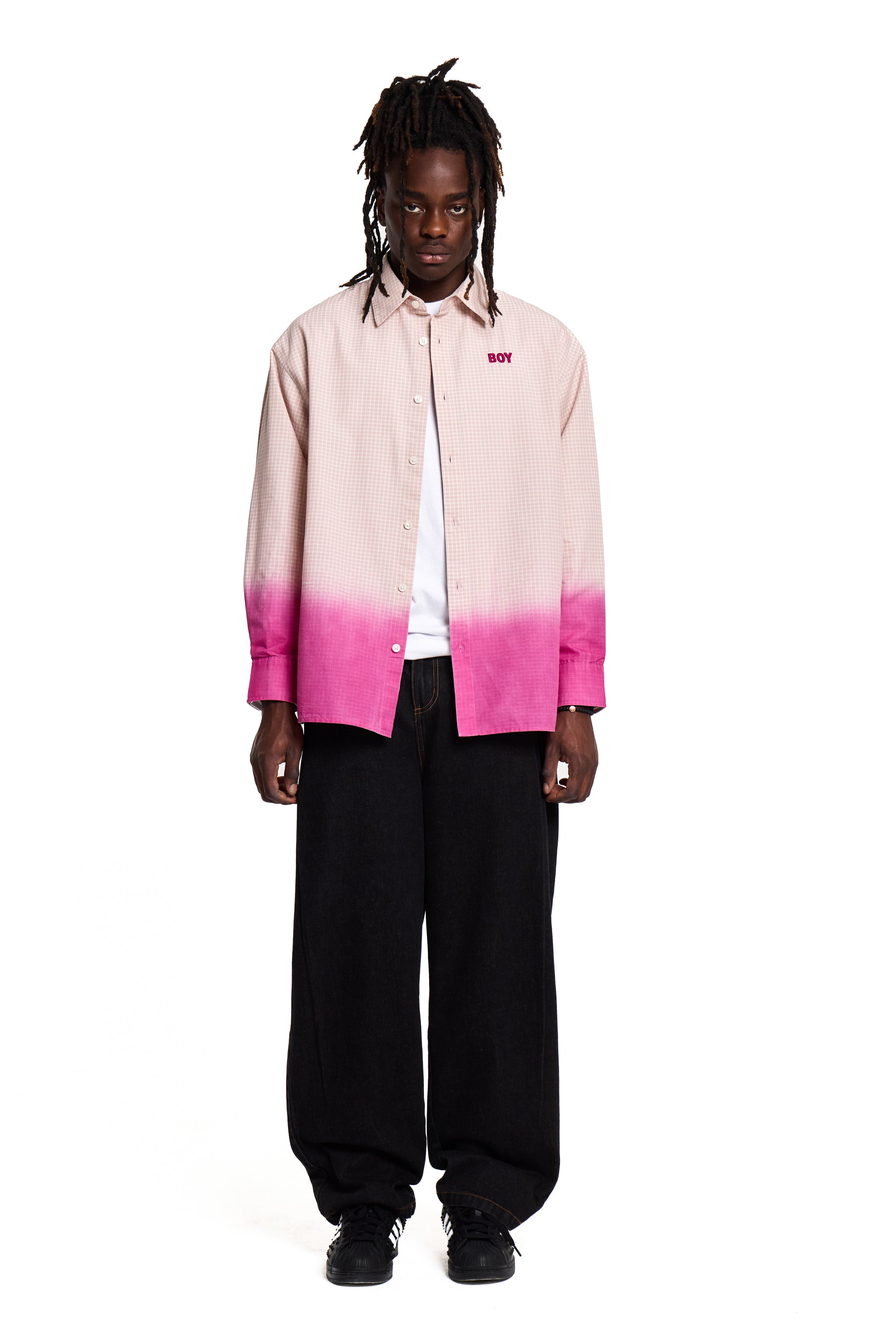 Person wearing a pink and black Boy London gradient shirt on a white background