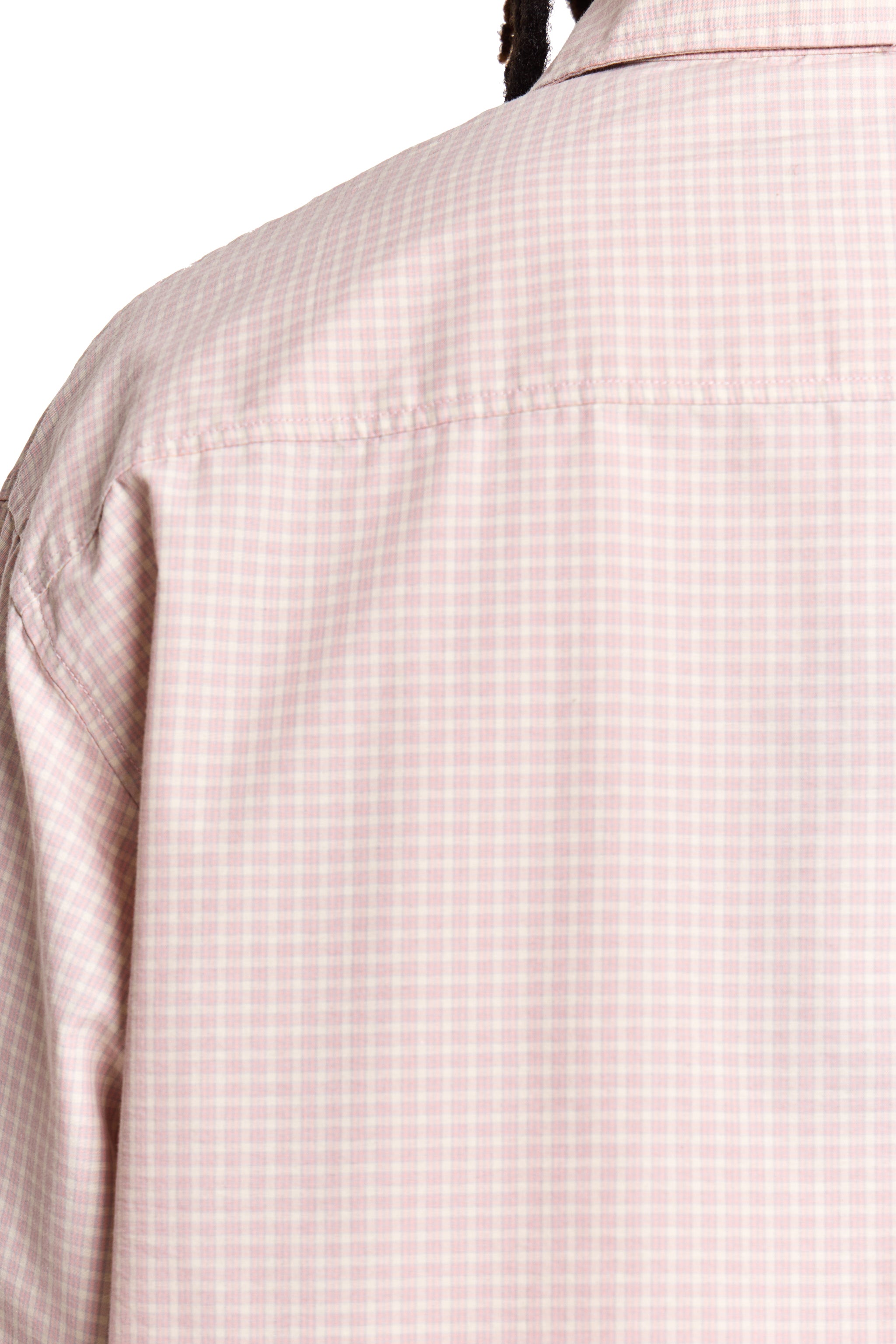 Close-up of a person wearing a light pink shirt.