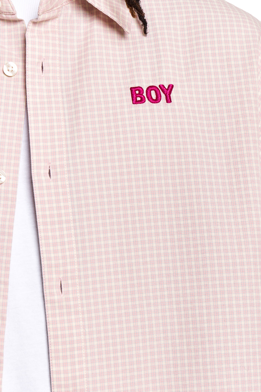 Close-up of a checkered shirt with 'BOY' embroidered on it.