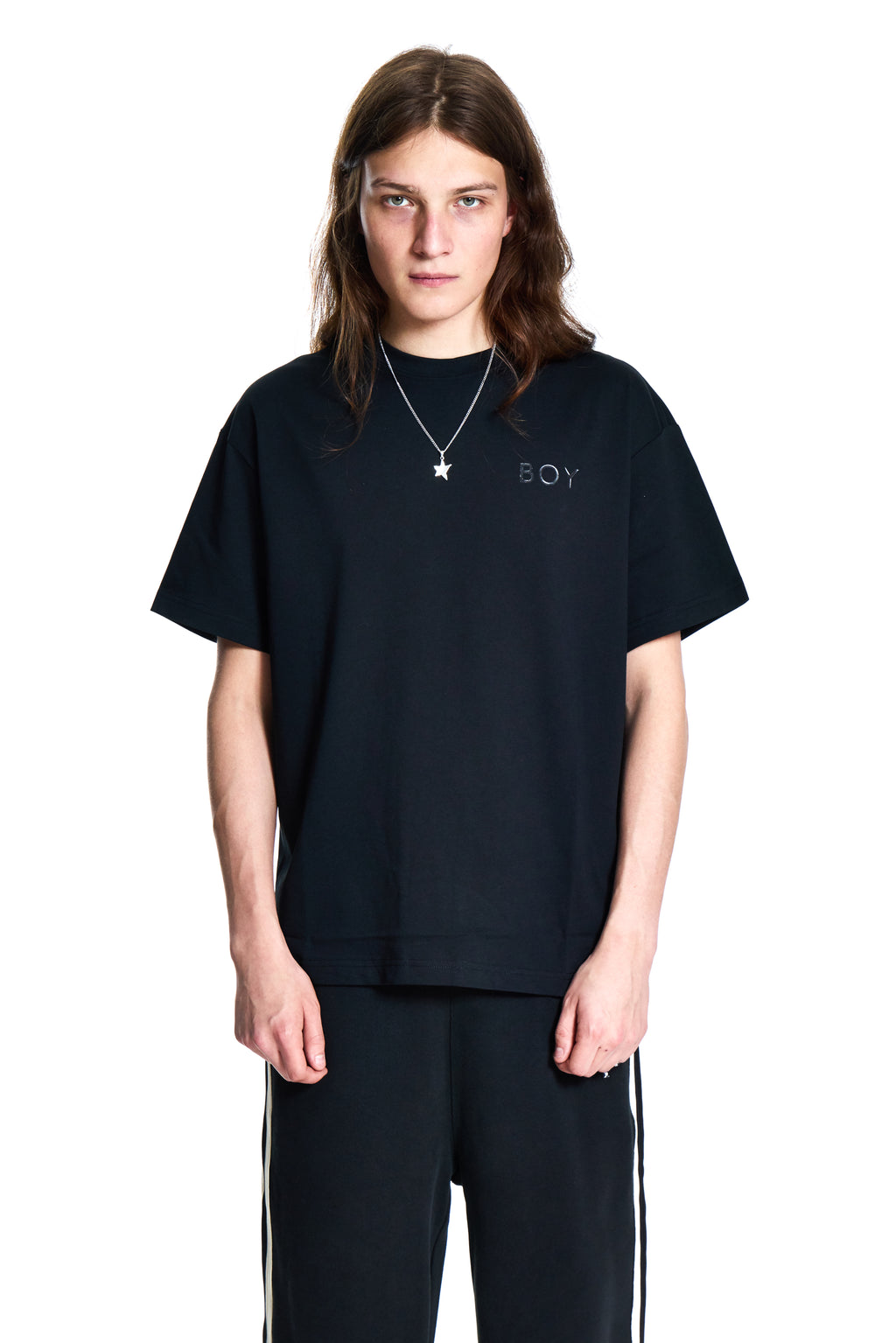 Person wearing a black t-shirt with 'BOY' London logo on a white background